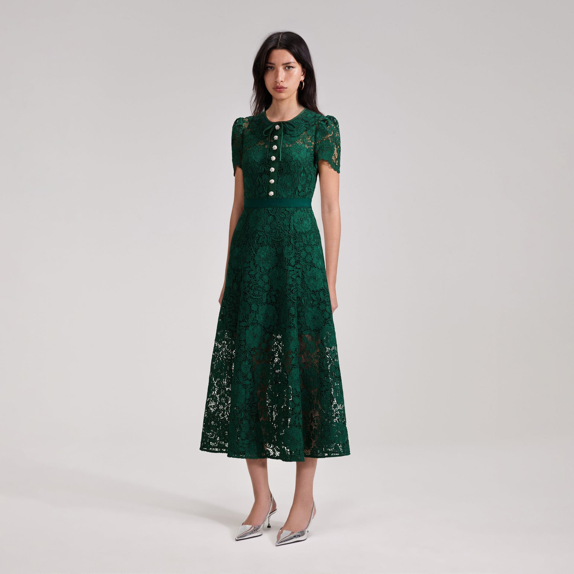 A woman wearing the Green Cord Lace Midi Dress