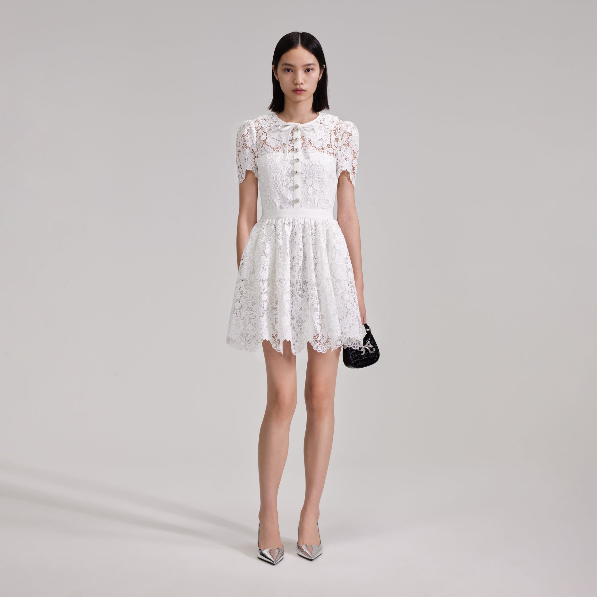 A woman wearing the White Cord Lace Collar Mini Dress