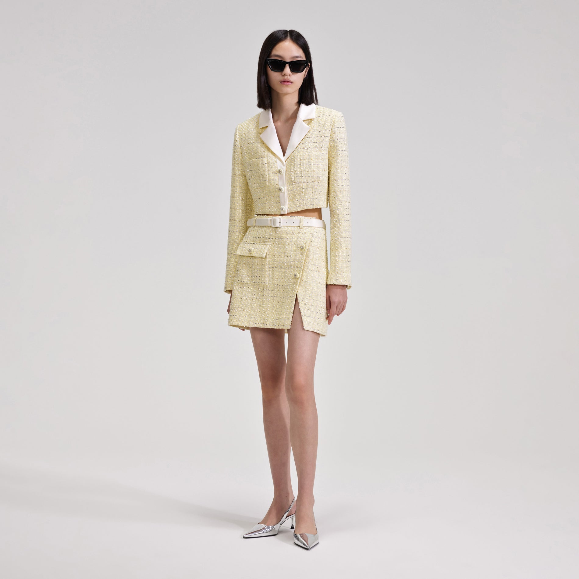 A woman wearing the Yellow Boucle Mini Skirt