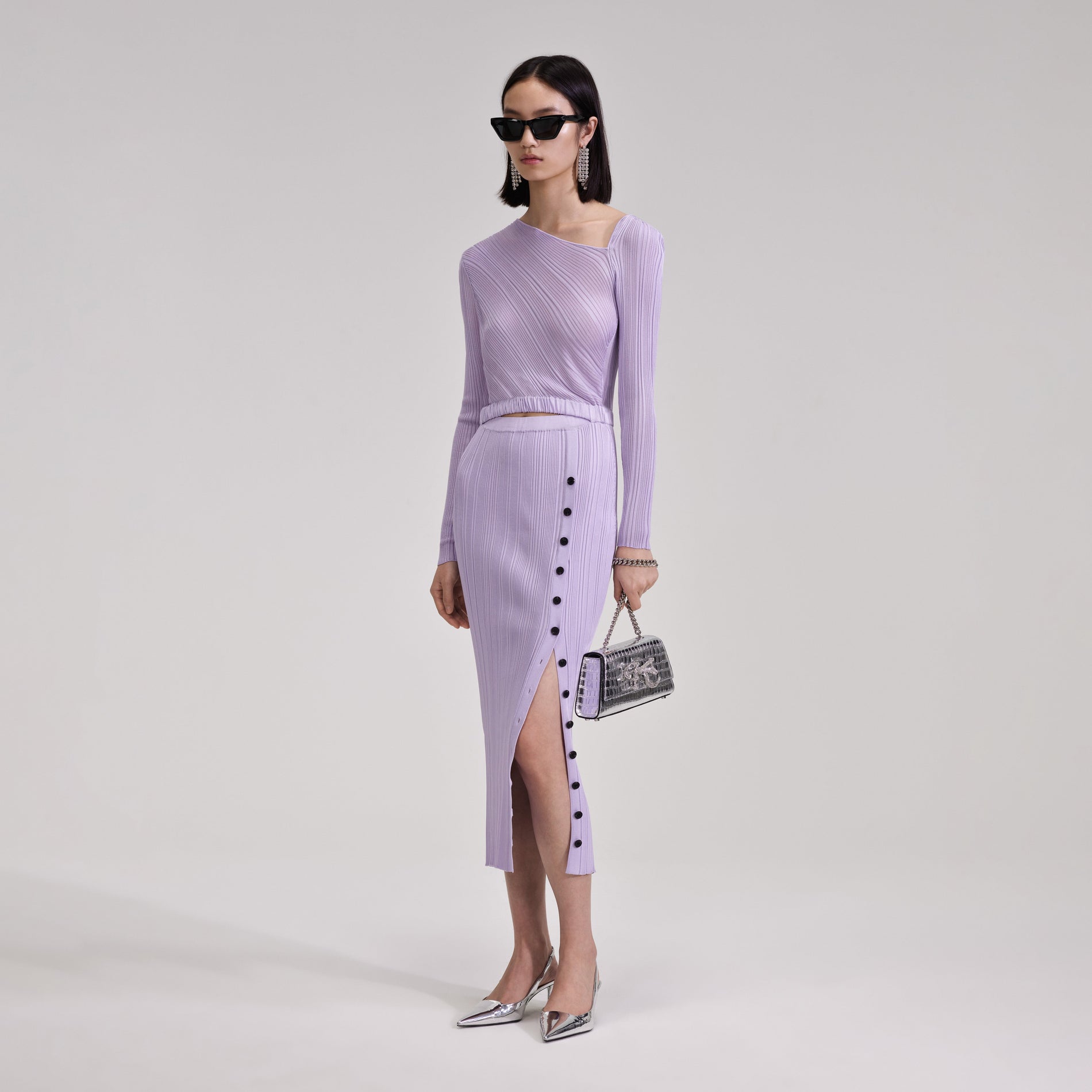 A woman wearing the Lilac Knit Midi Dress