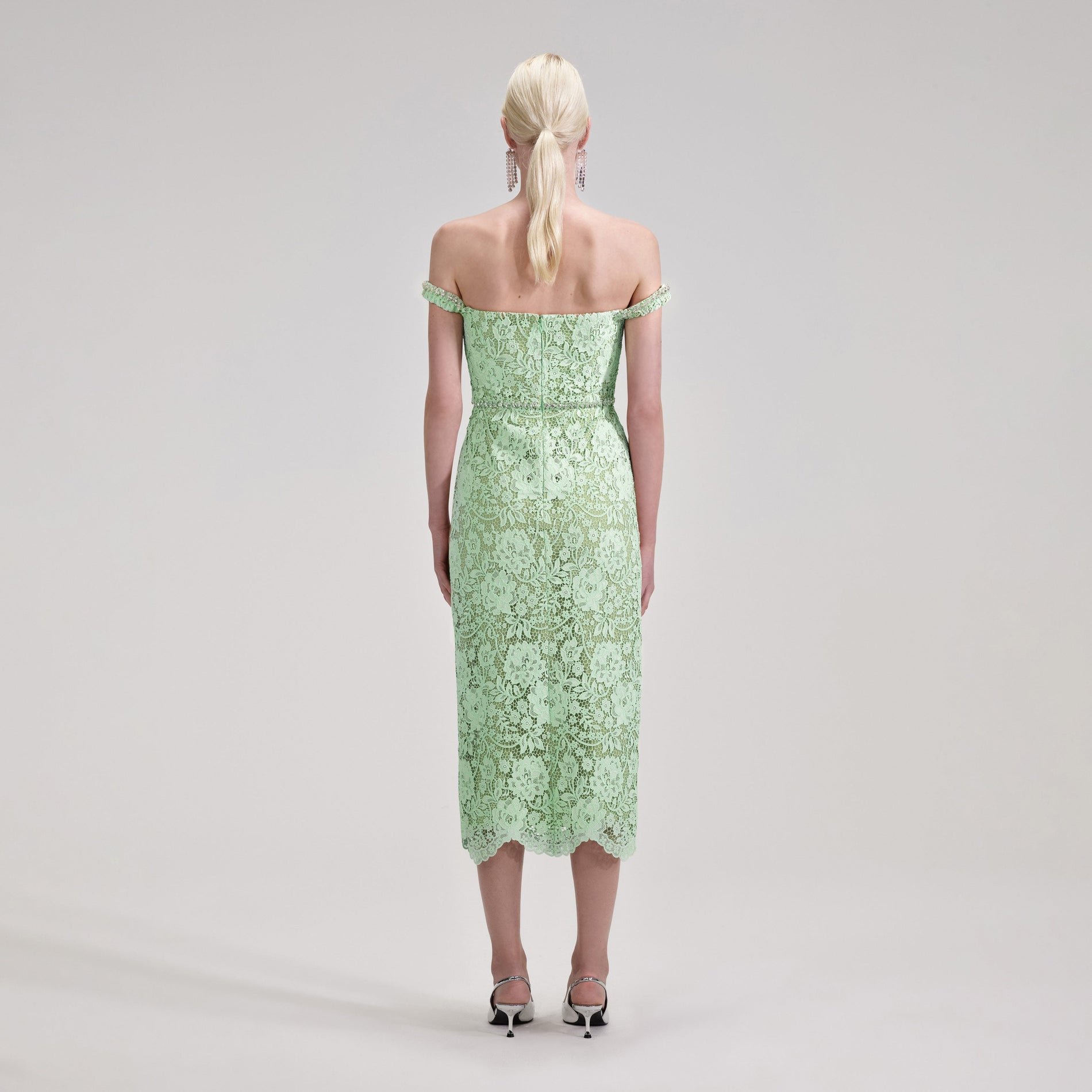 Back view of a woman wearing the Green Cord Lace Diamante Midi Dress