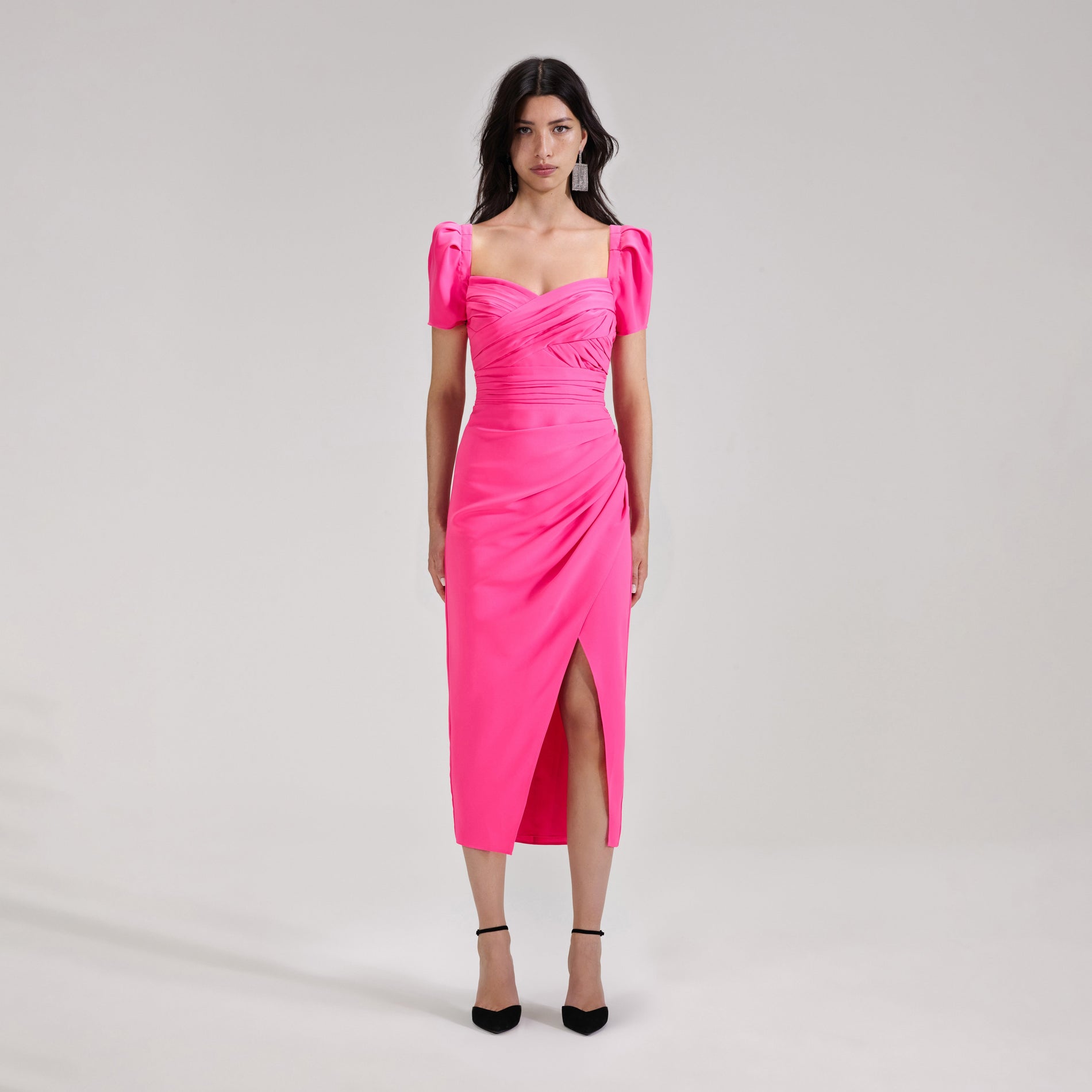 A woman wearing the Bright Pink Iris Midi Dress