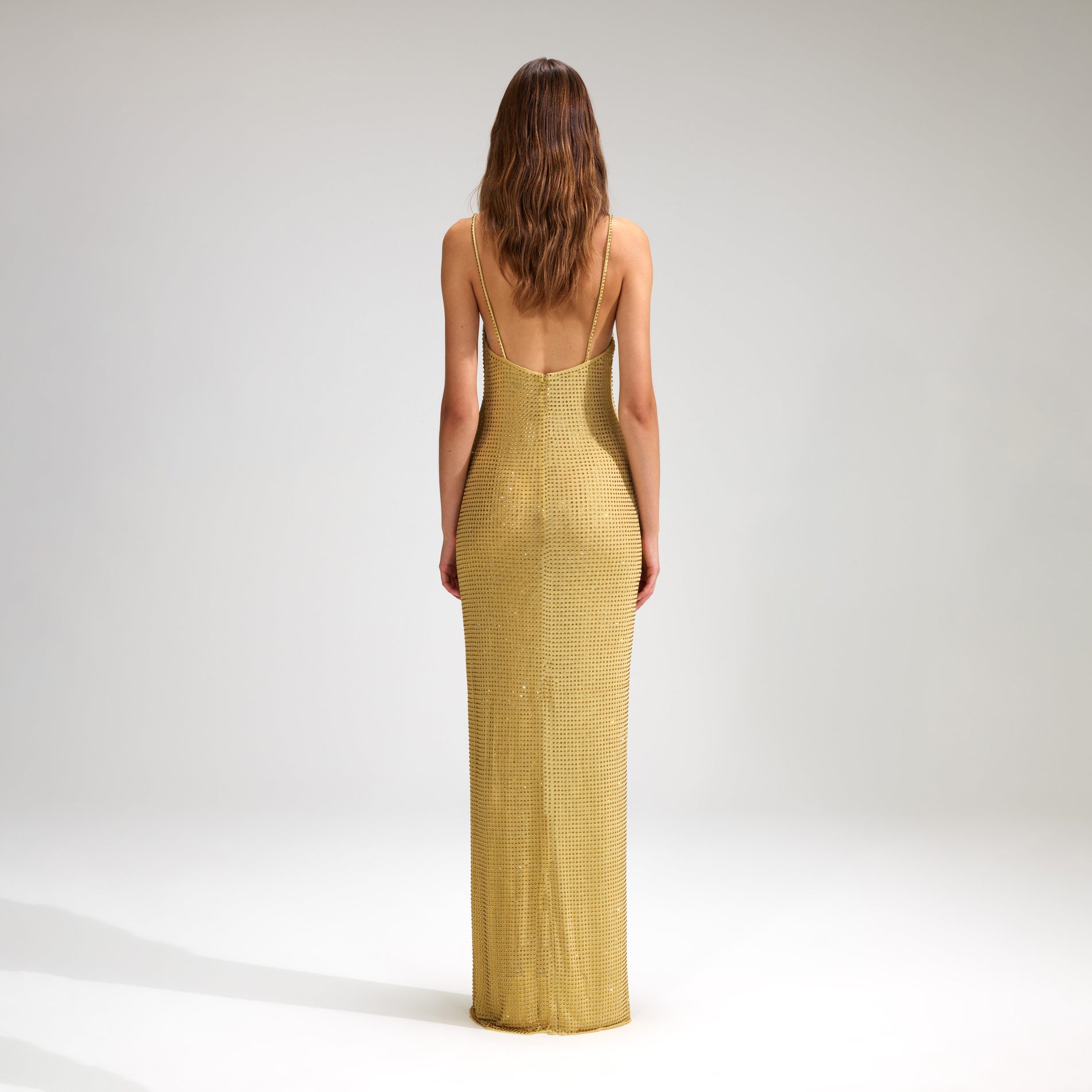 A woman wearing the Yellow Rhinestone Mesh Maxi Dress