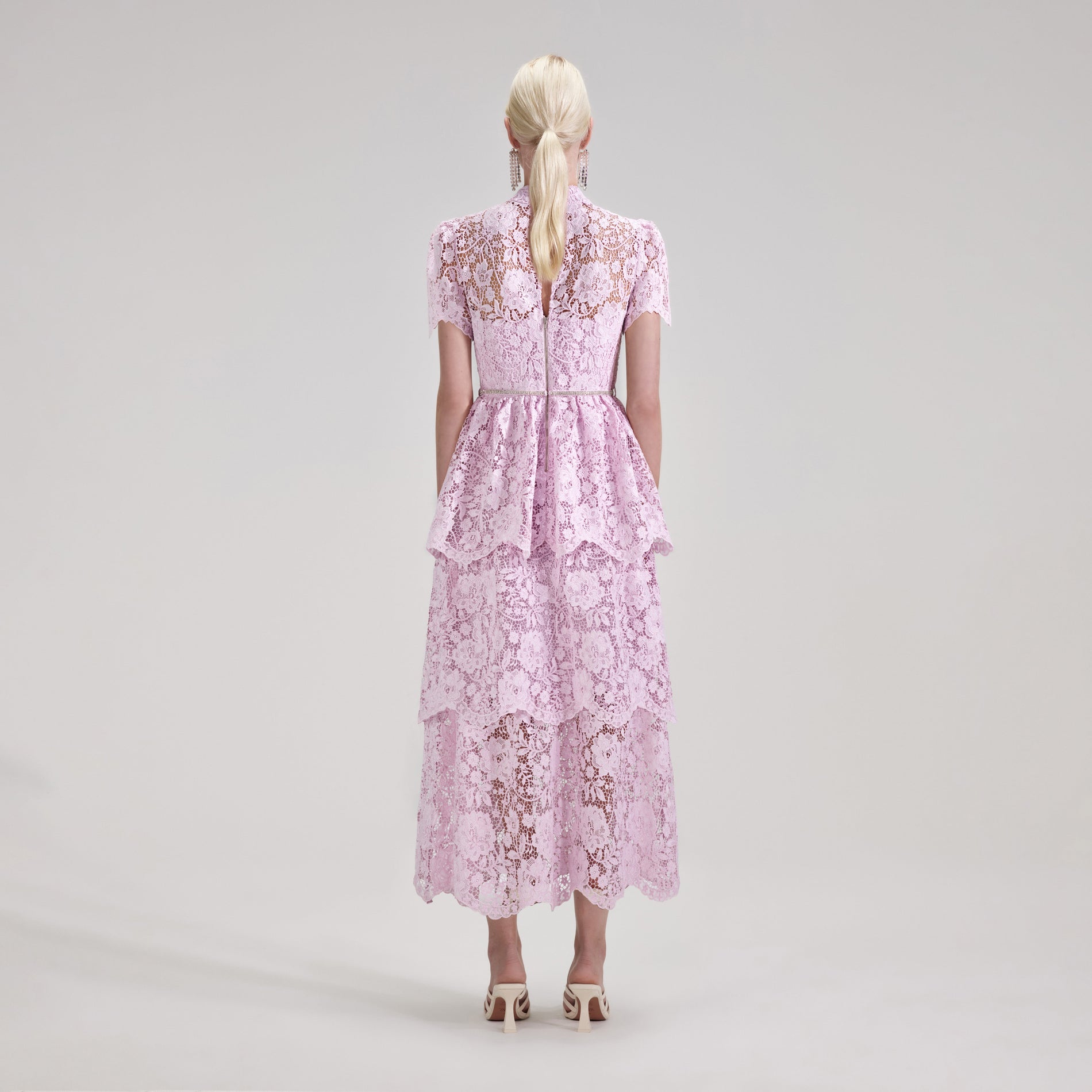 A woman wearing the Pink Cord Lace Tiered Midi Dress