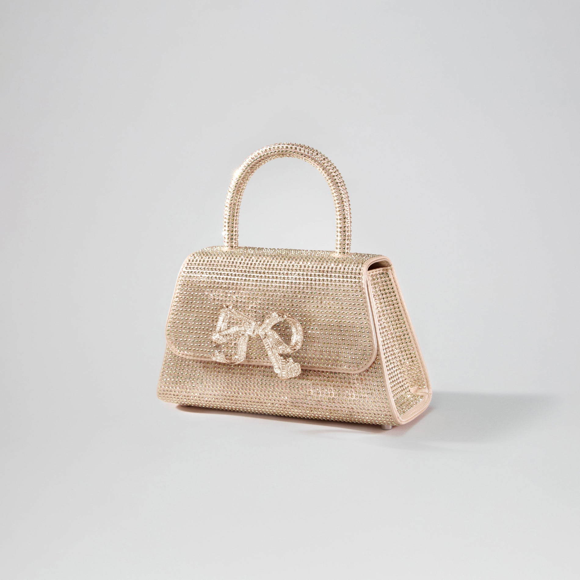 Side view of a woman wearing the Gold Rhinestone Mini Bow Bag