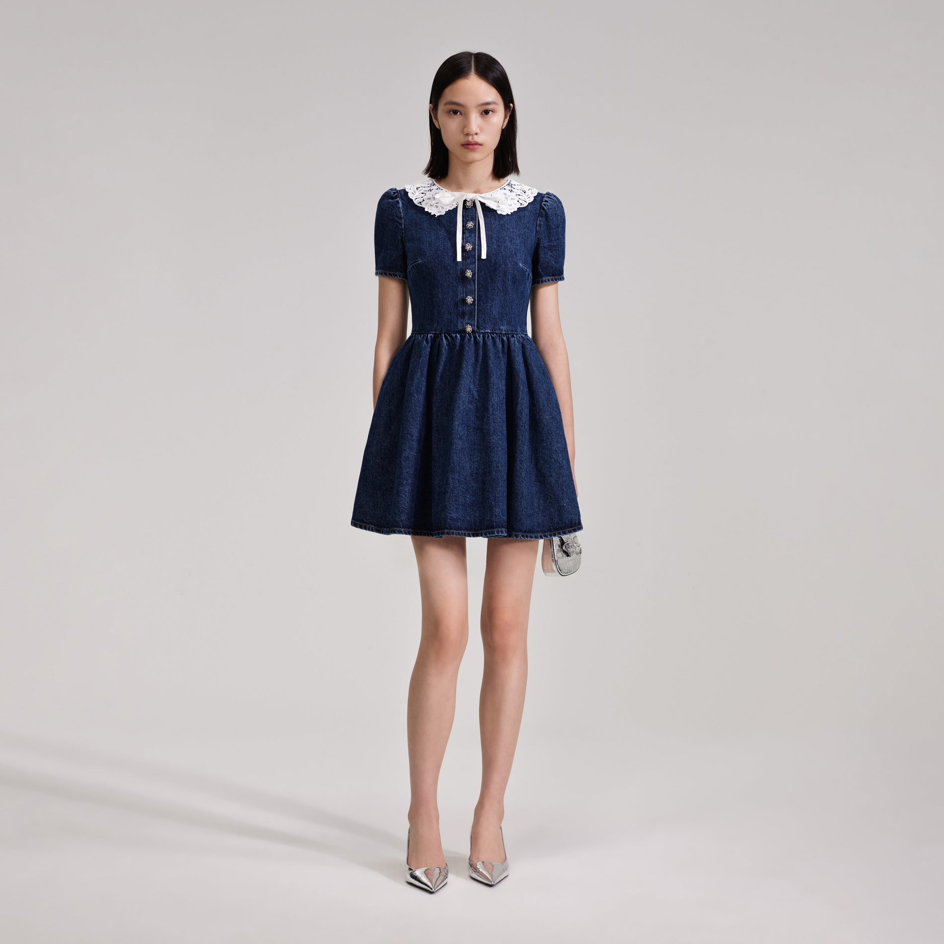 A woman wearing the Lace Collar Denim Mini Dress