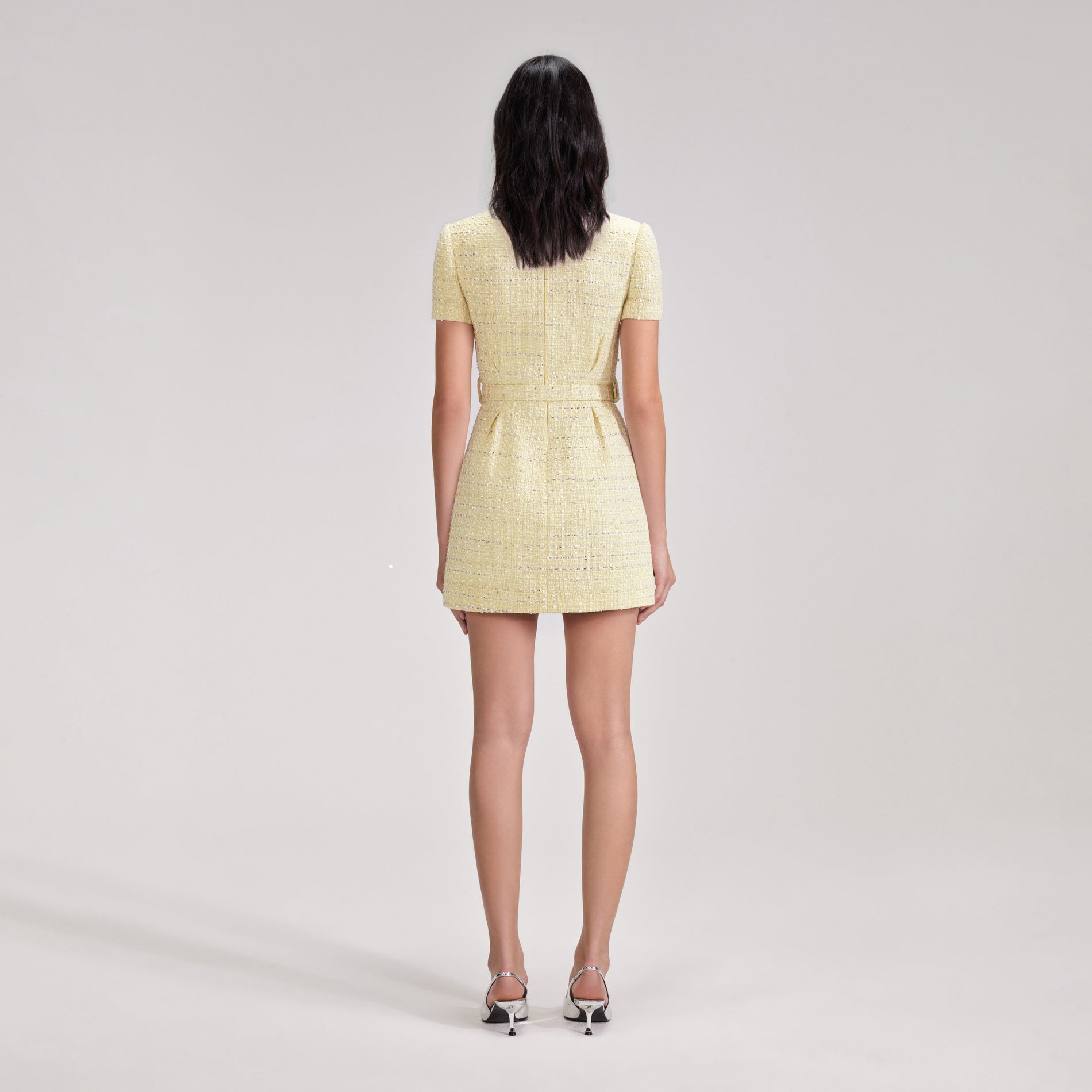 A woman wearing the Yellow Boucle Mini Dress