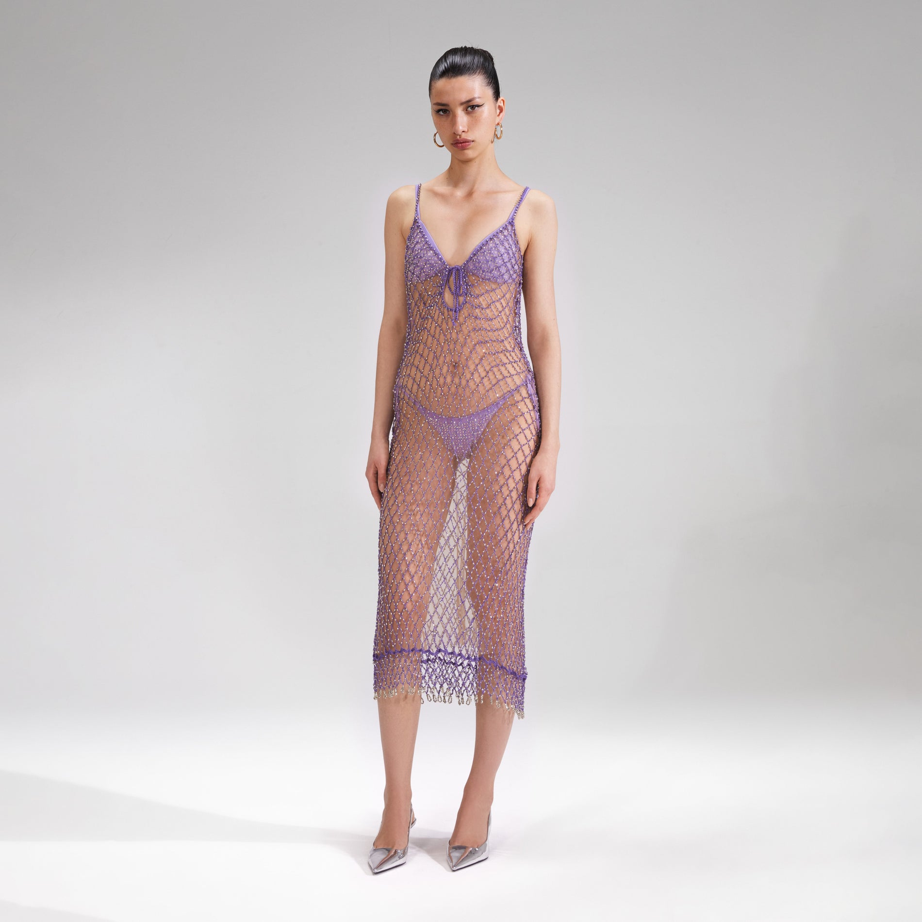 A woman wearing the Purple Beaded Fishnet Midi Dress
