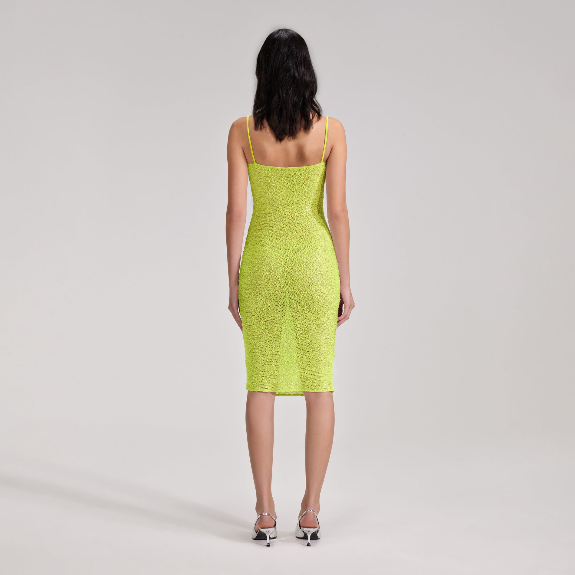 A woman wearing the Green Beaded Midi Dress