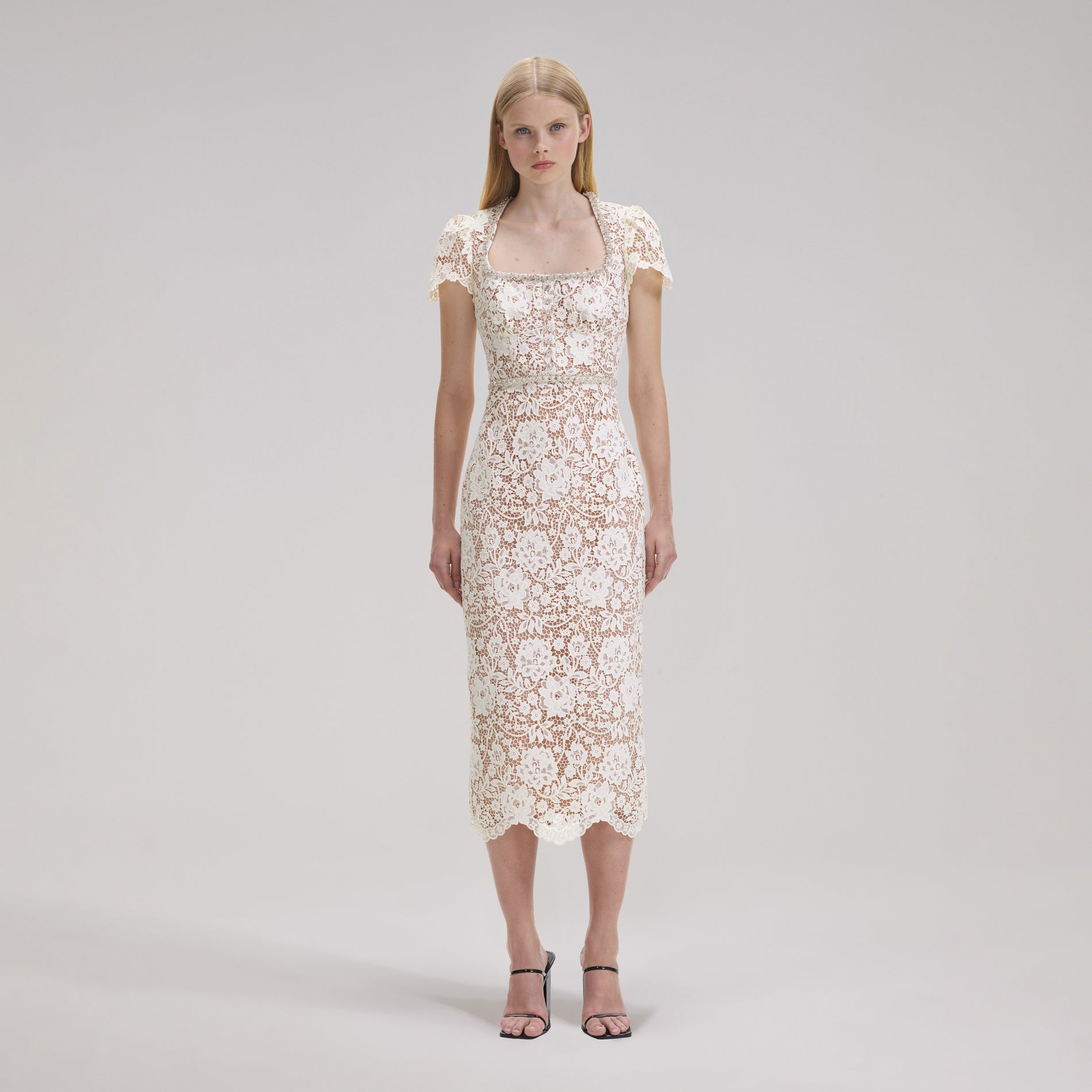 A woman wearing the Cream Cord Lace Diamante Midi Dress