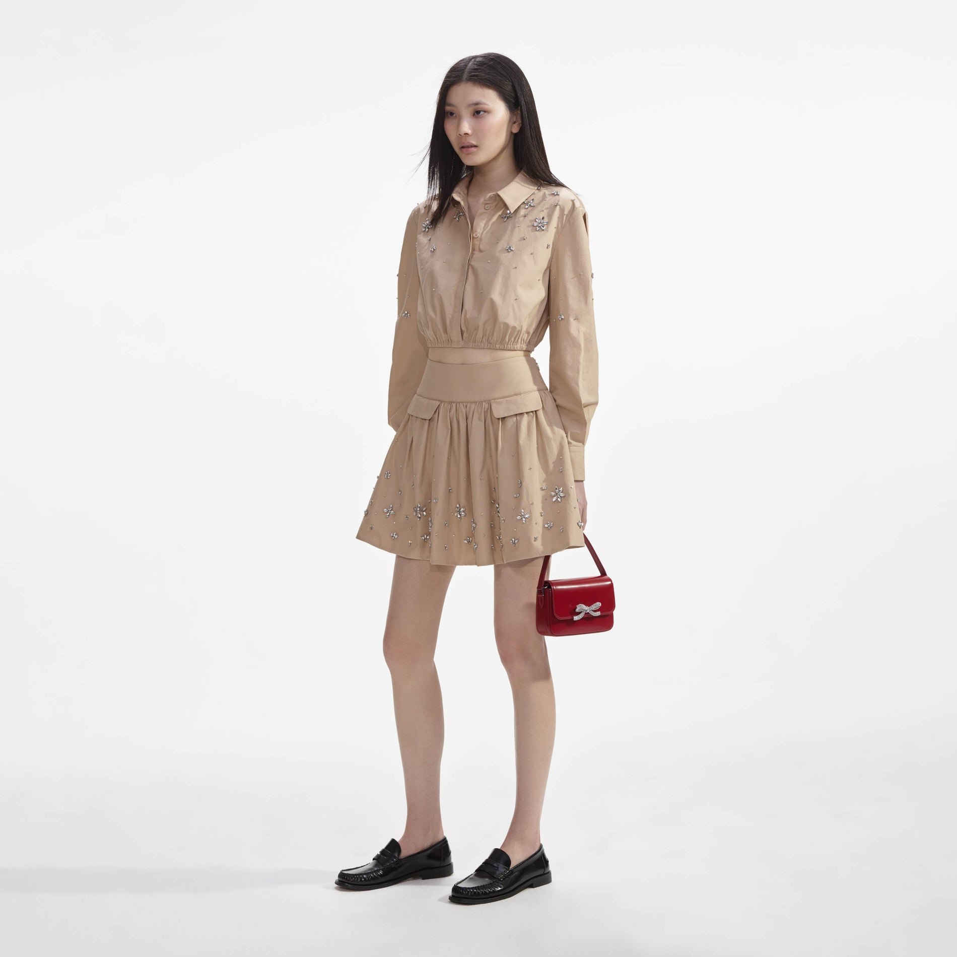 Side view of a woman wearing the Beige Cotton Embellished Top