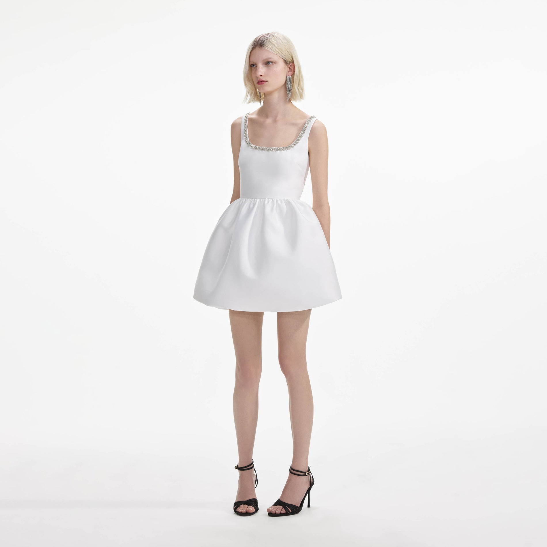 Side view of a woman wearing the White Taffeta Diamante Mini Dress
