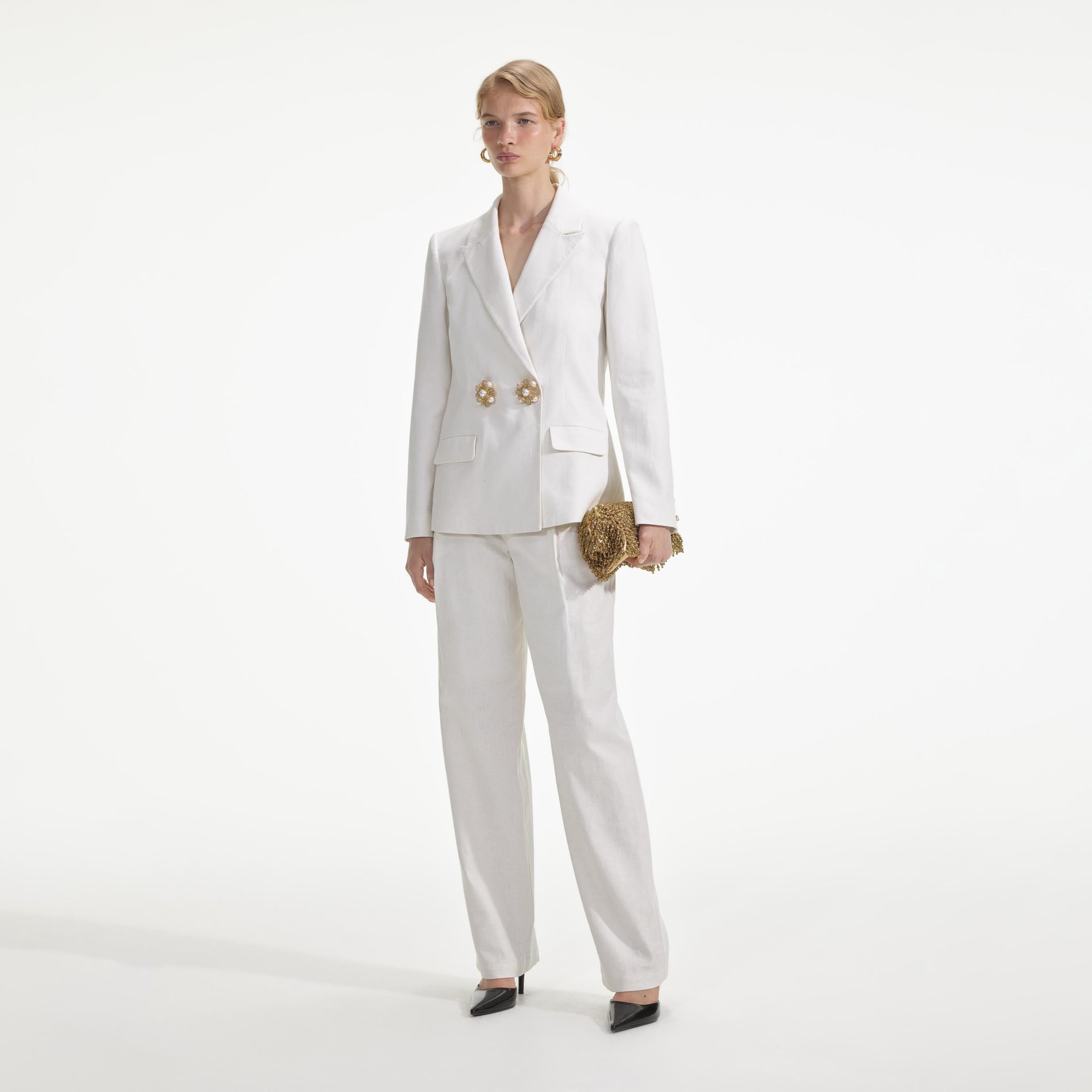 Side view of a woman wearing the White Linen Blazer