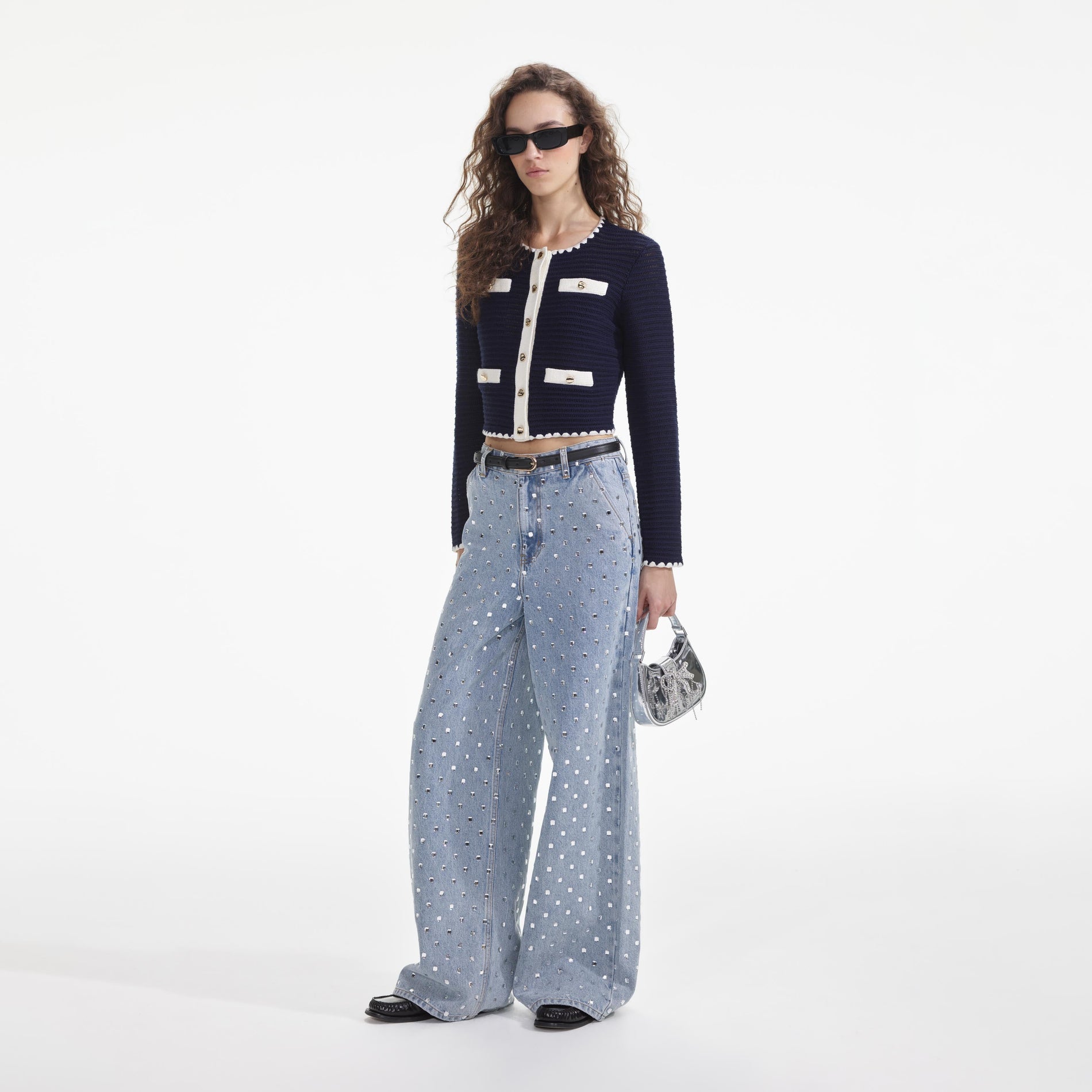 Side view of a woman wearing the Navy Crochet Contrast Trim Cardigan