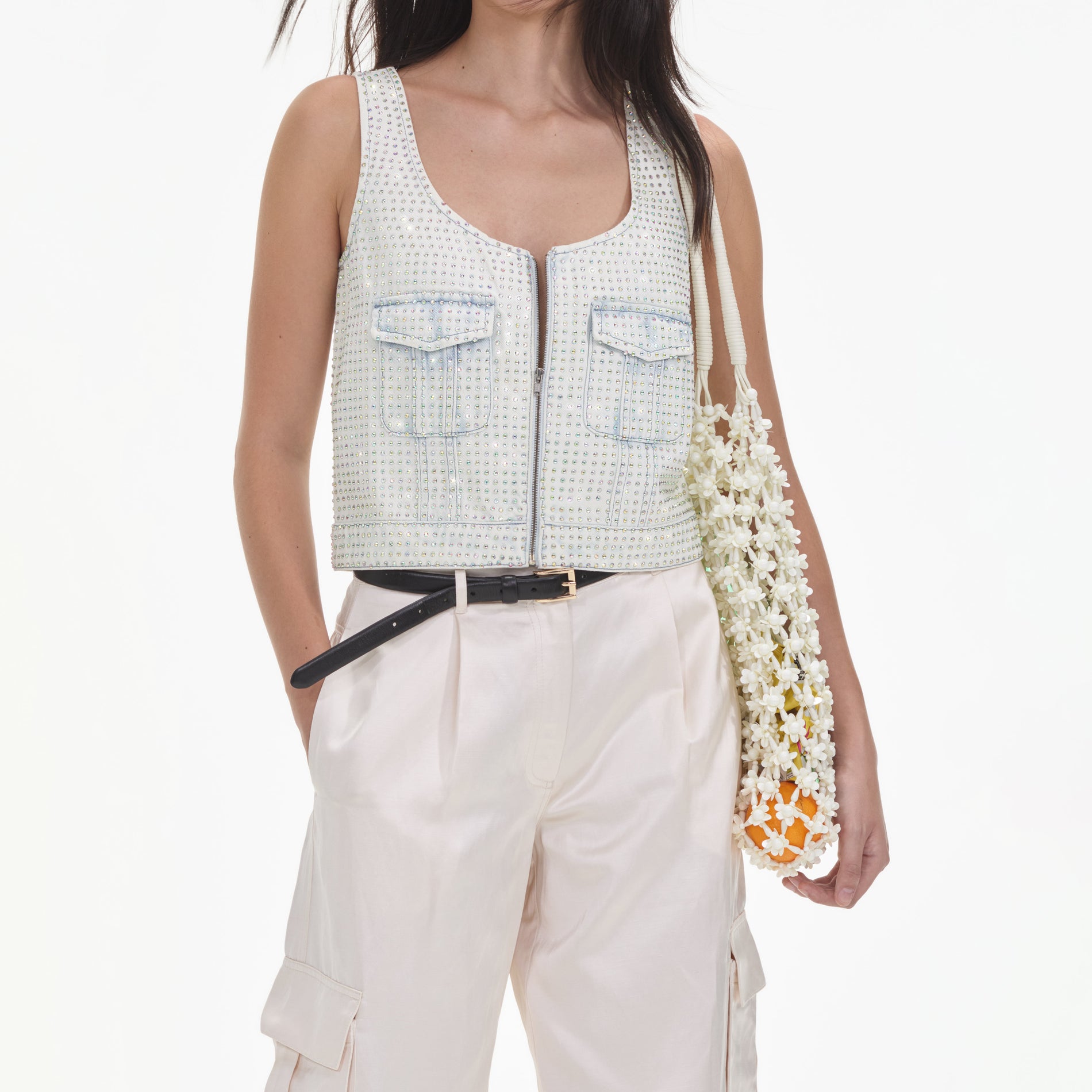 A close up of a woman wearing the Cream Satin Cargo Trousers