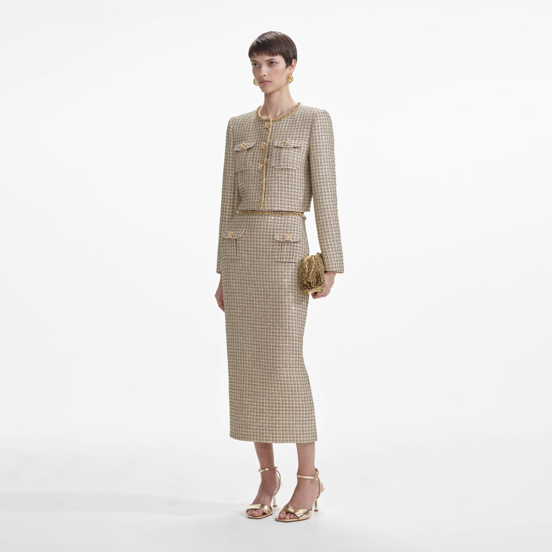 Side view of a woman wearing the Gold Boucle Midi Skirt