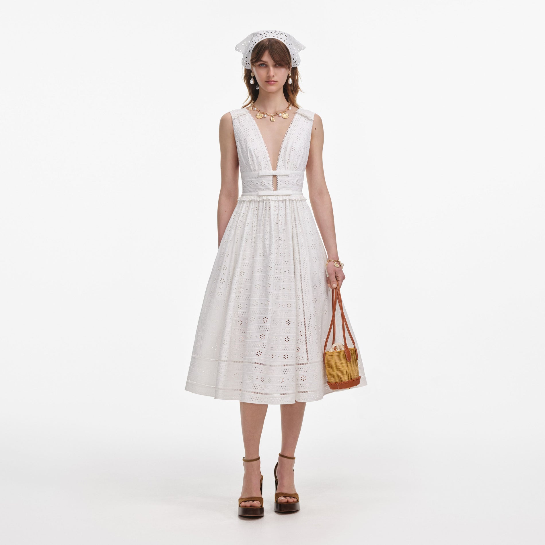 Front view of a woman wearing the White Cotton Broderie Midi Dress