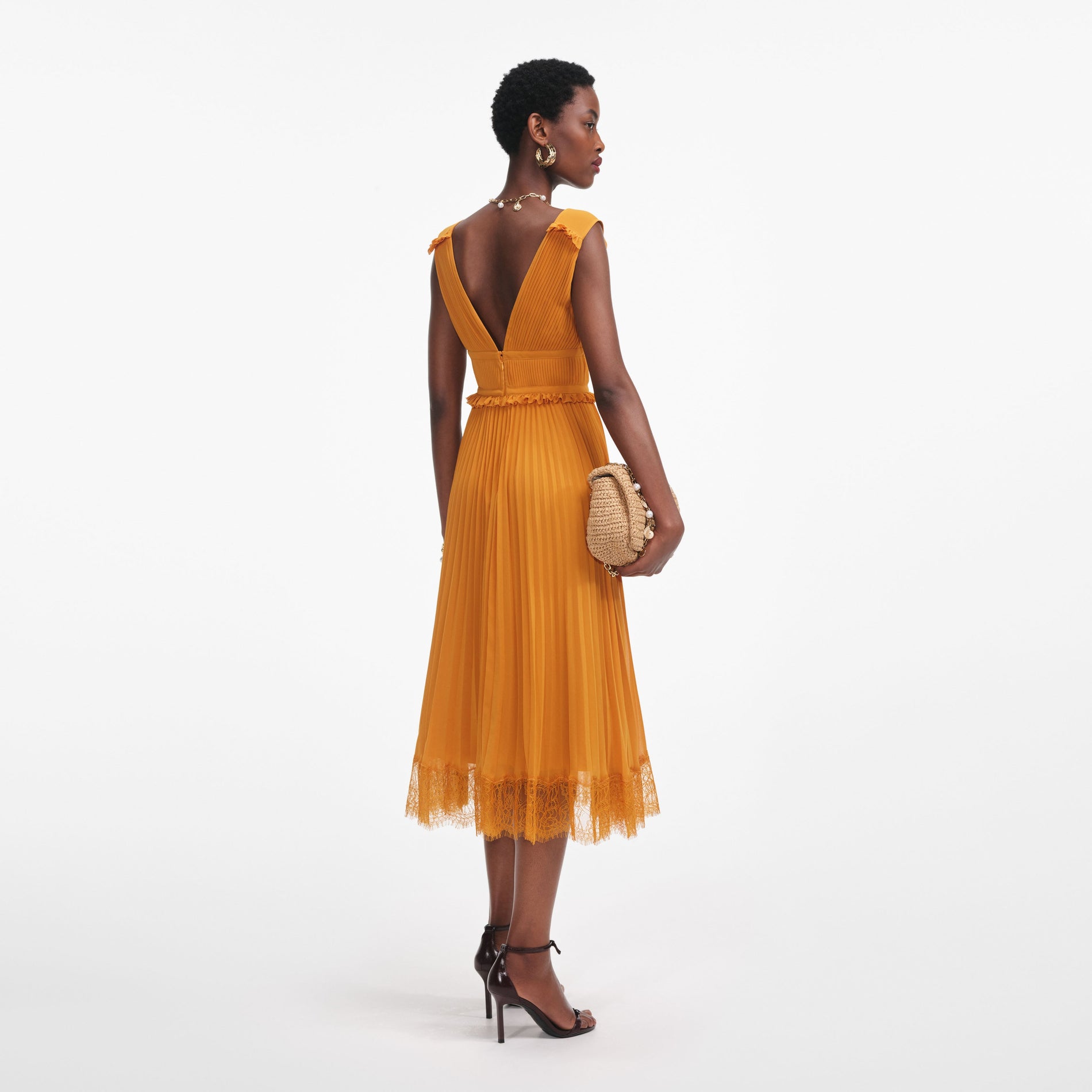 Back view of a woman wearing the Burnt Orange Chiffon Midi Dress