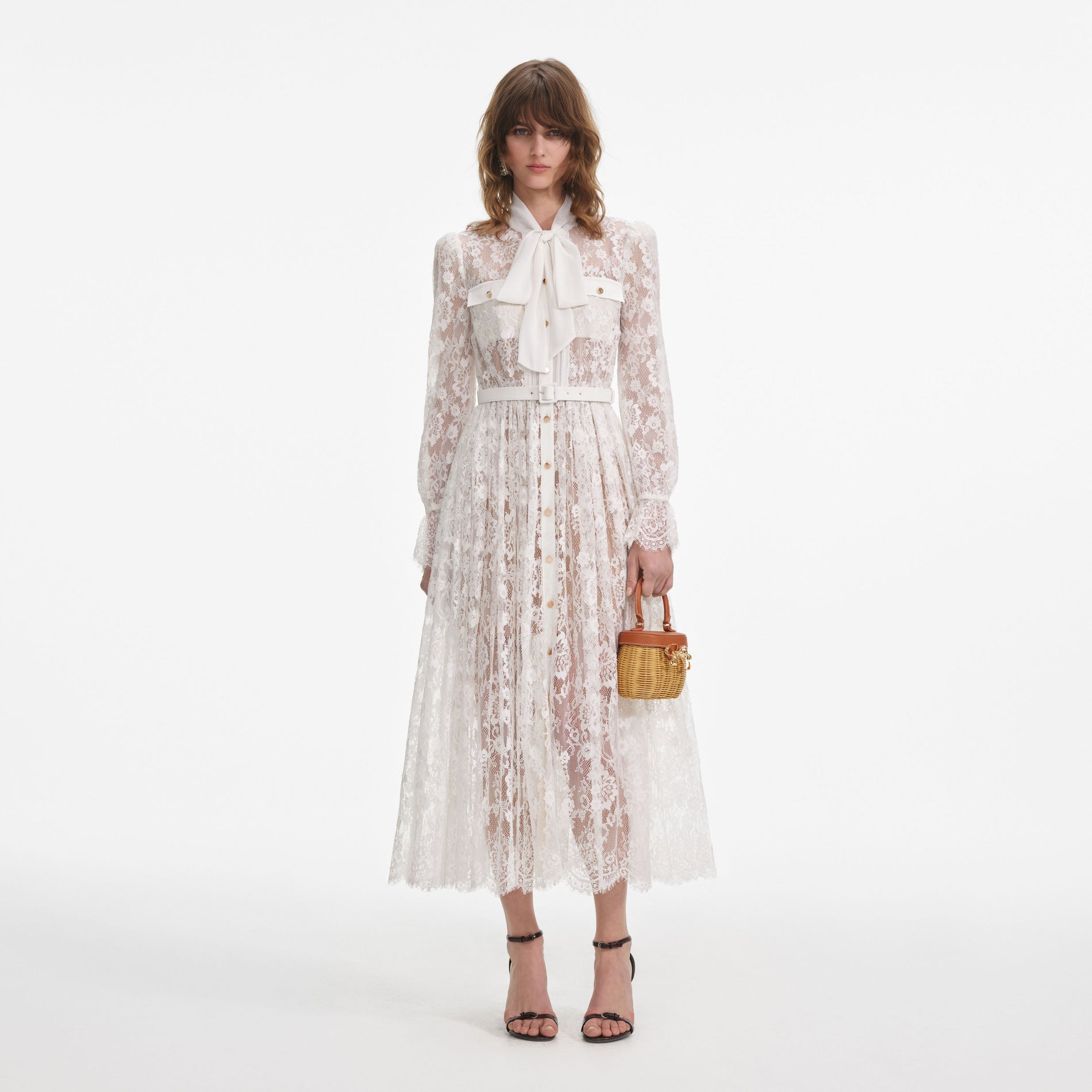 Front view of a woman wearing the White Lace Pussy Bow Midi Dress