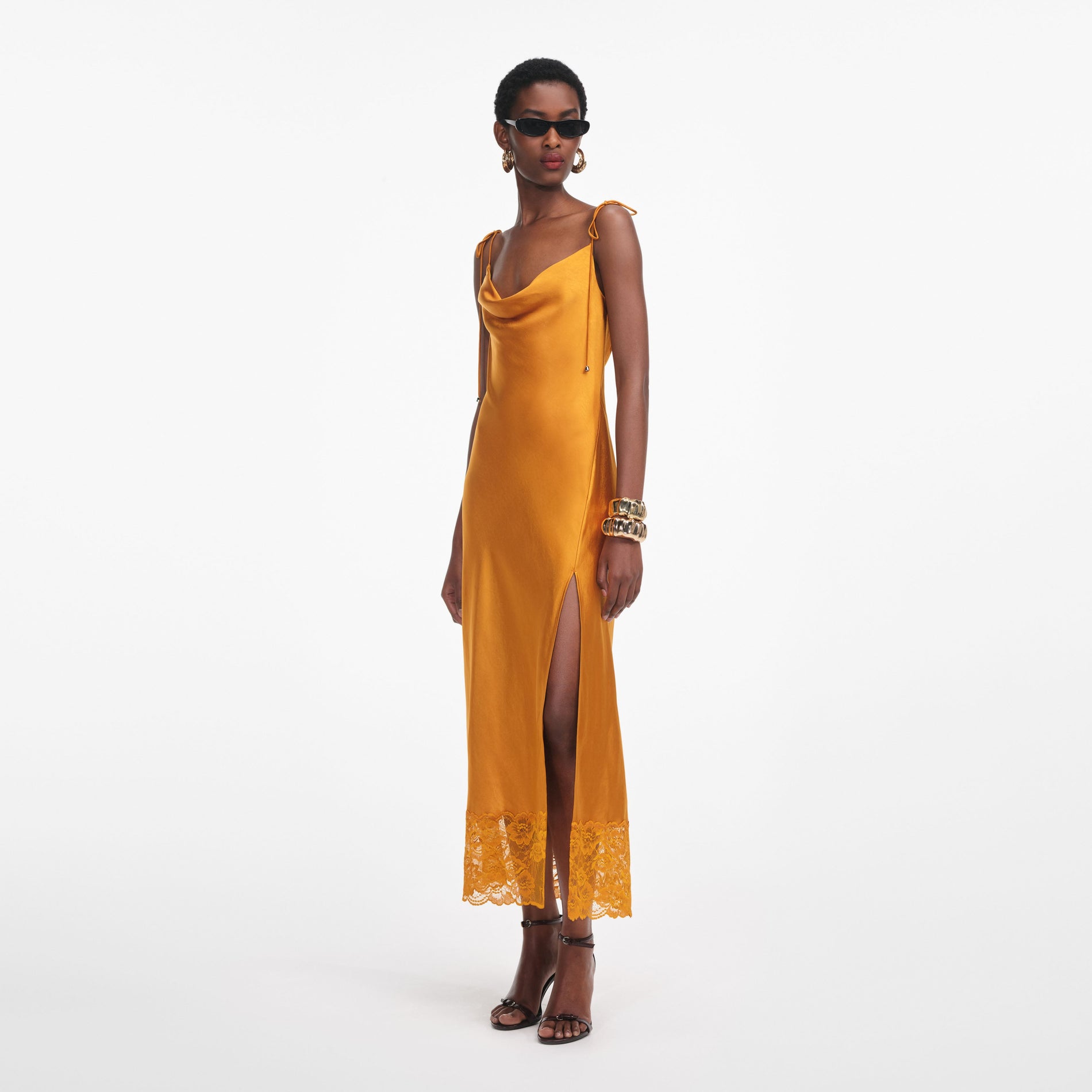 Side view of a woman wearing the Burnt Orange Satin Midi Dress