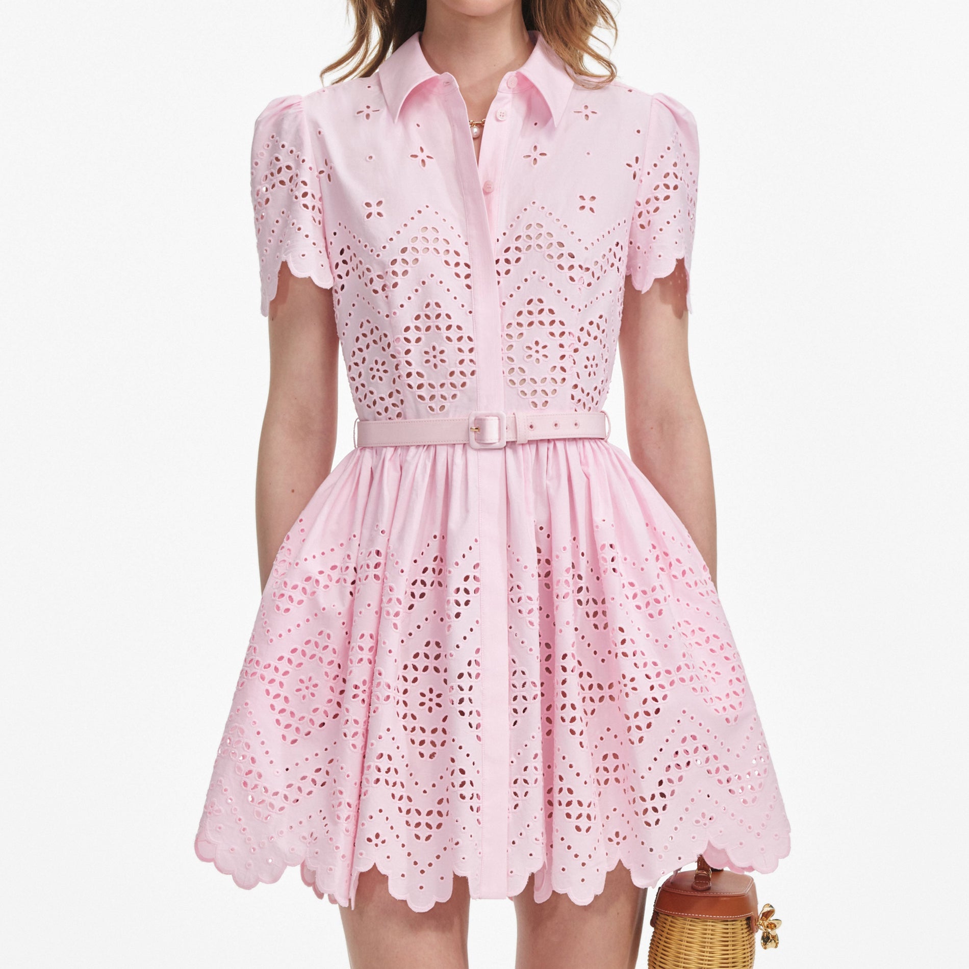 A close up of a woman wearing the Pink Cotton Broderie Mini Dress