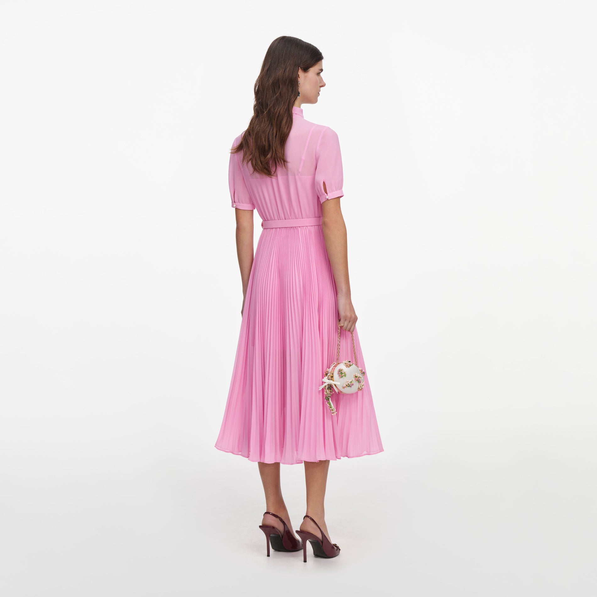 Back view of a woman wearing the Pink Georgette Tie Neck Midi Dress