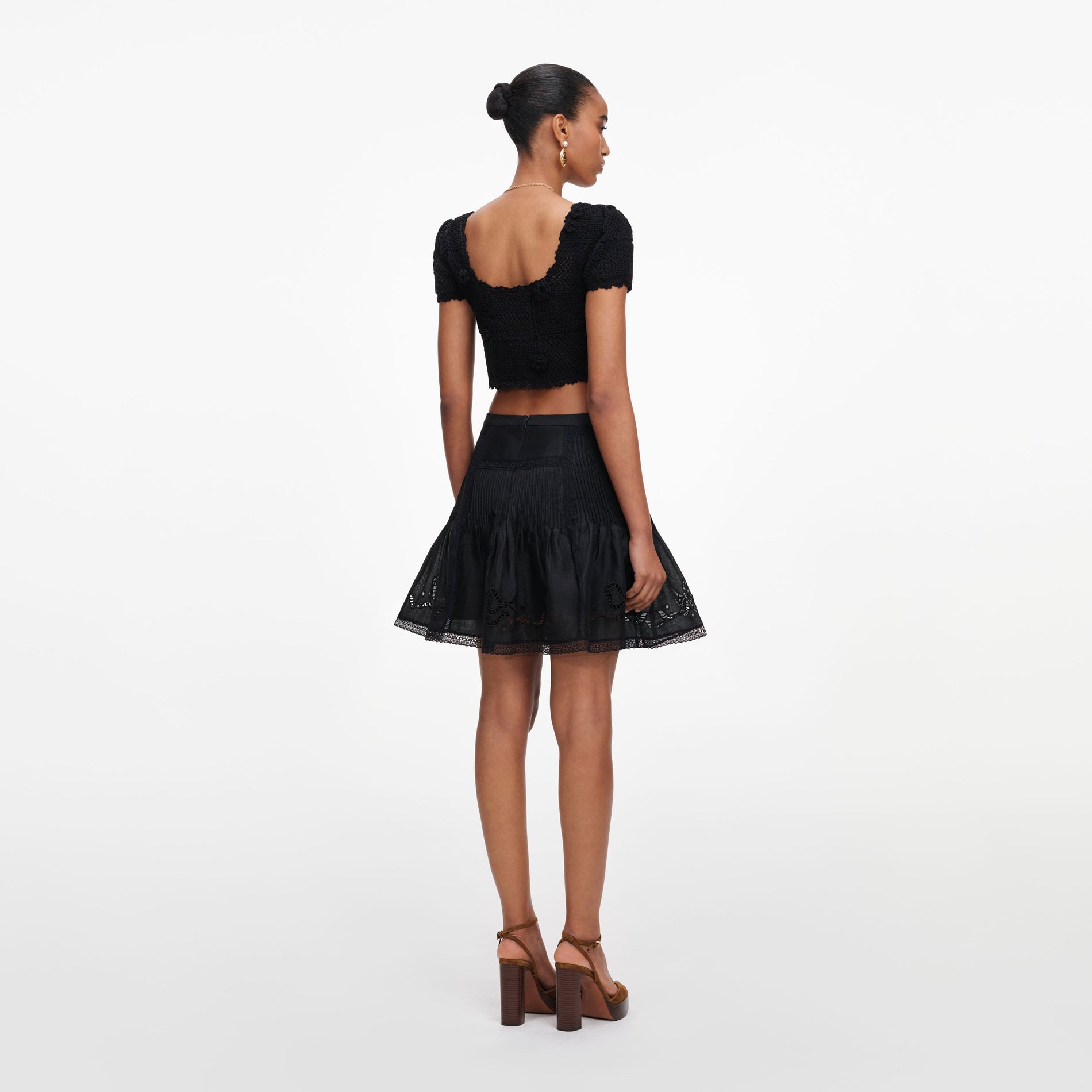 Back view of a woman wearing the Black Embroidered Mini Skirt