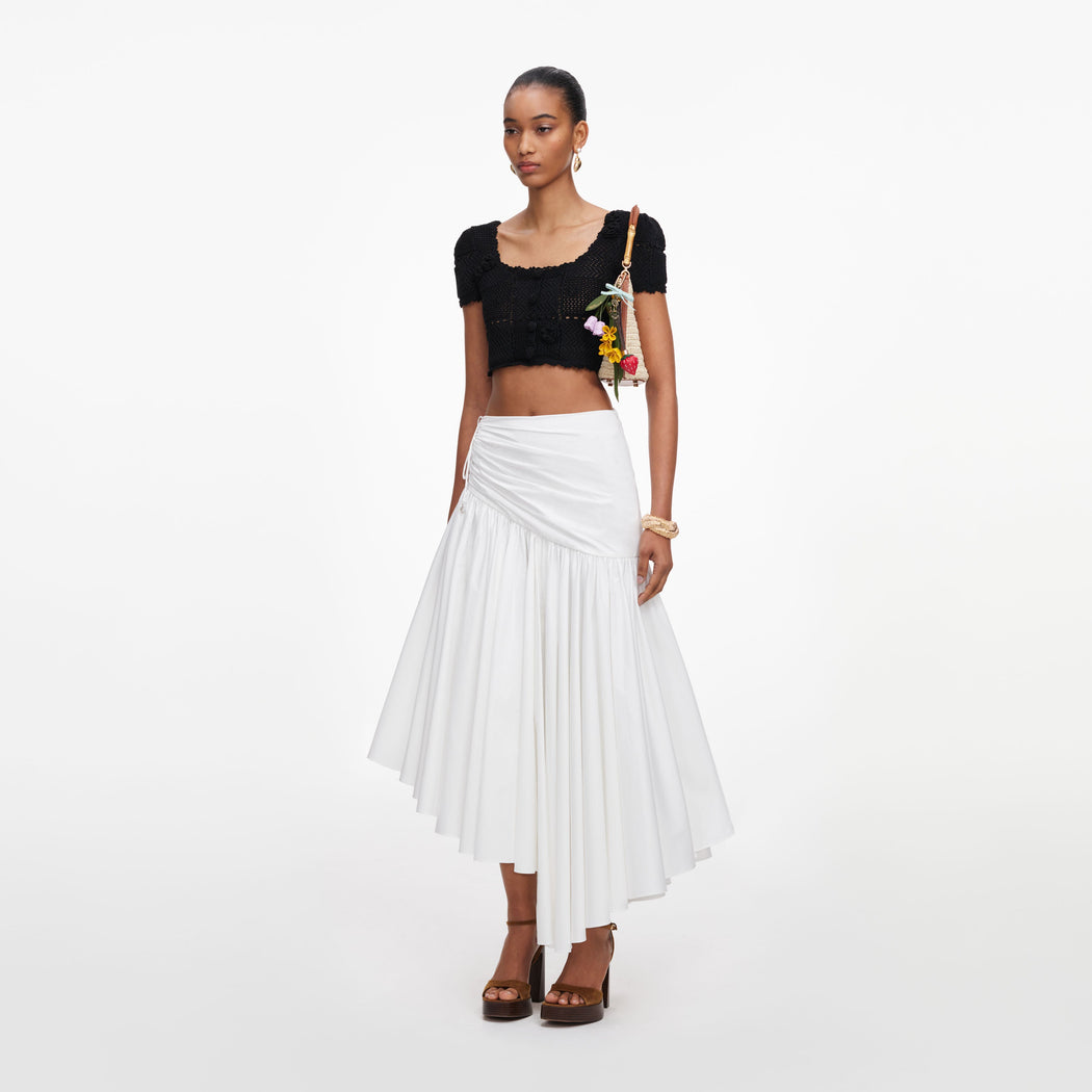 Side view of a woman wearing the Black Crochet Knit Crop Top
