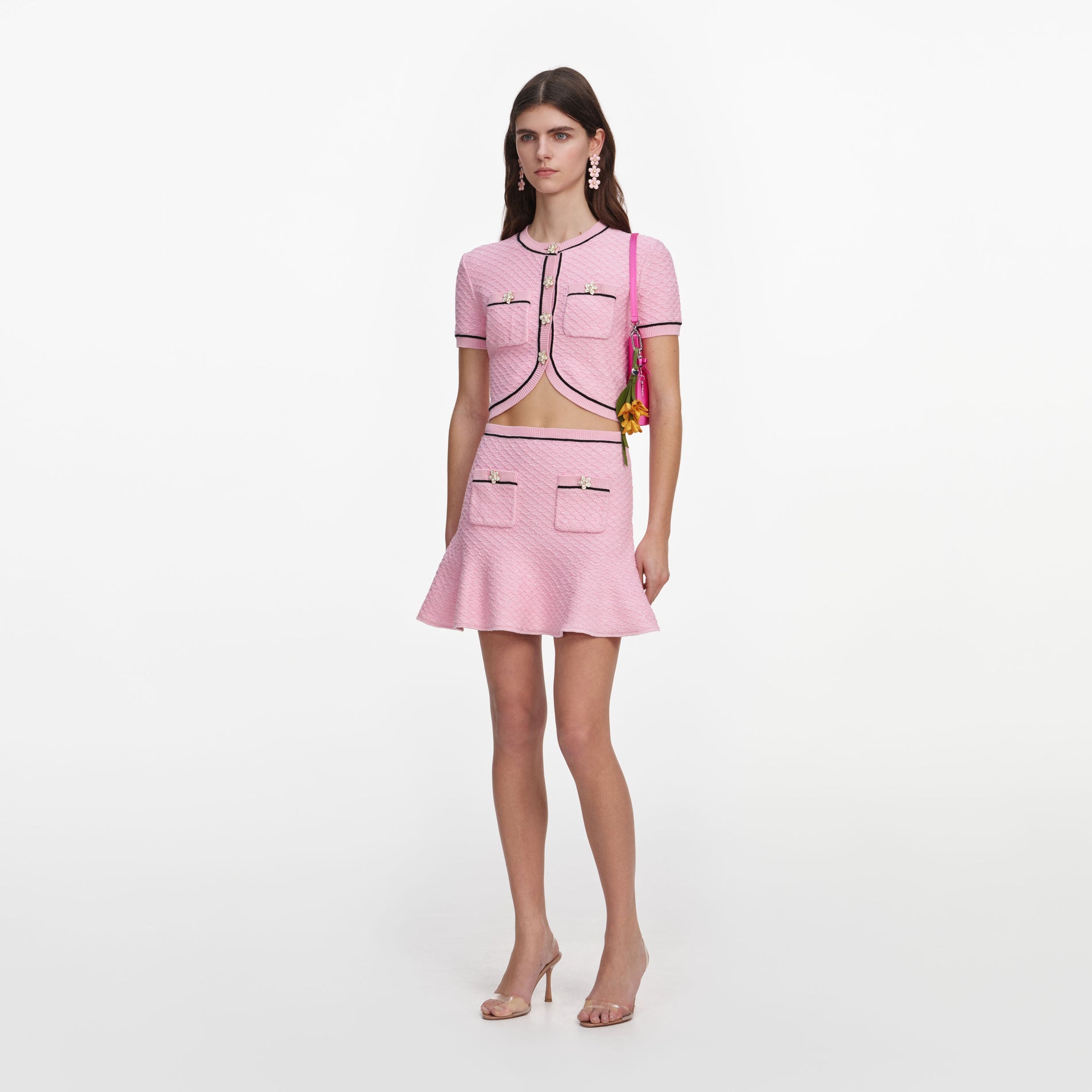 Side view of a woman wearing the Pink Flower Knit Mini Skirt