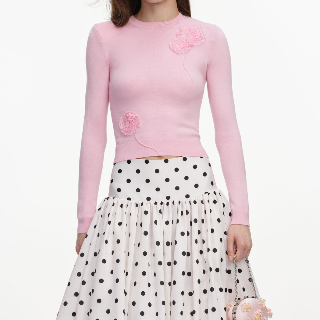 A close up of a woman wearing the Pink Flower Knit Jumper