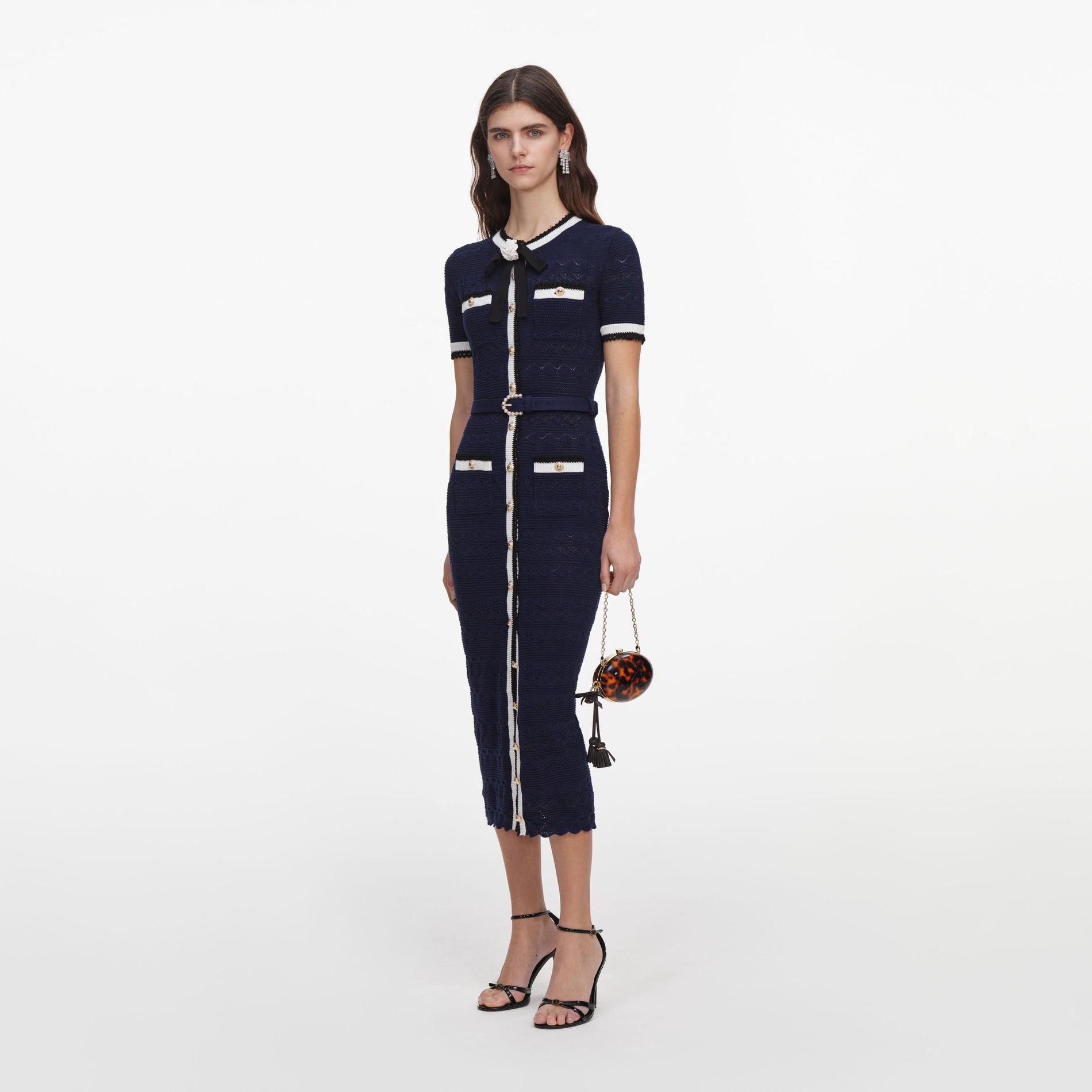 Side view of a woman wearing the Navy Pointelle Knit Midi Dress