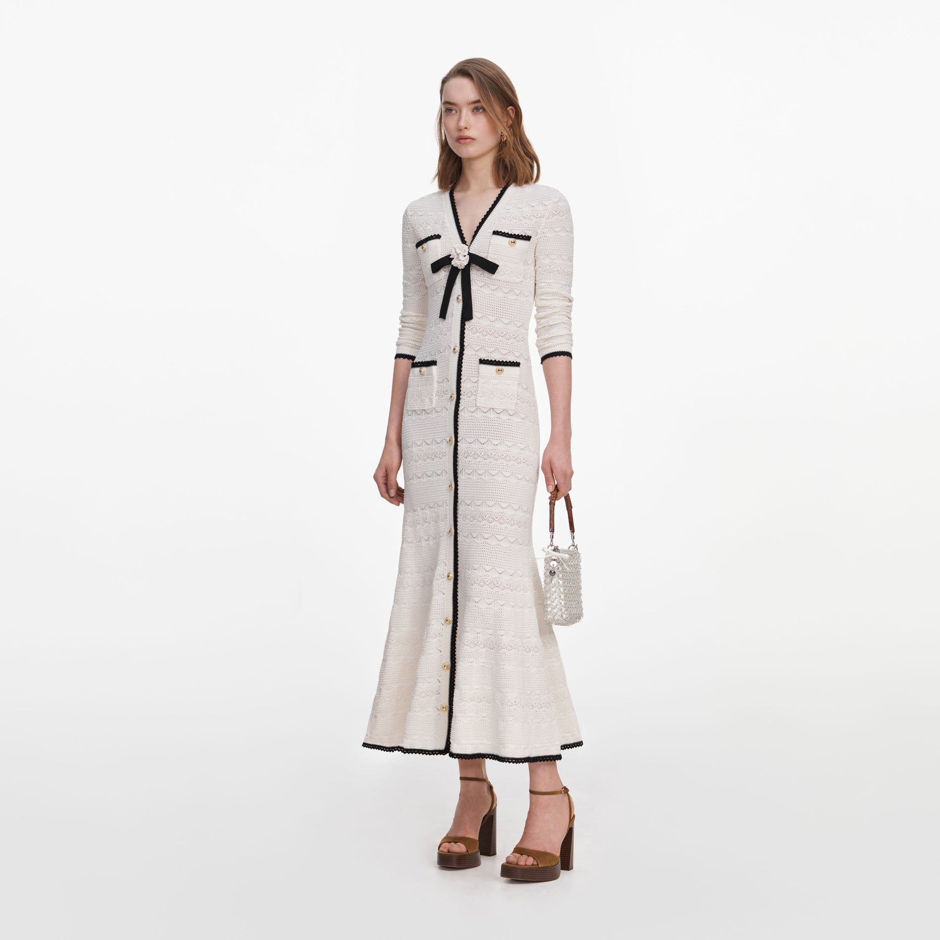 Side view of a woman wearing the White Pointelle Knit Long Cardigan