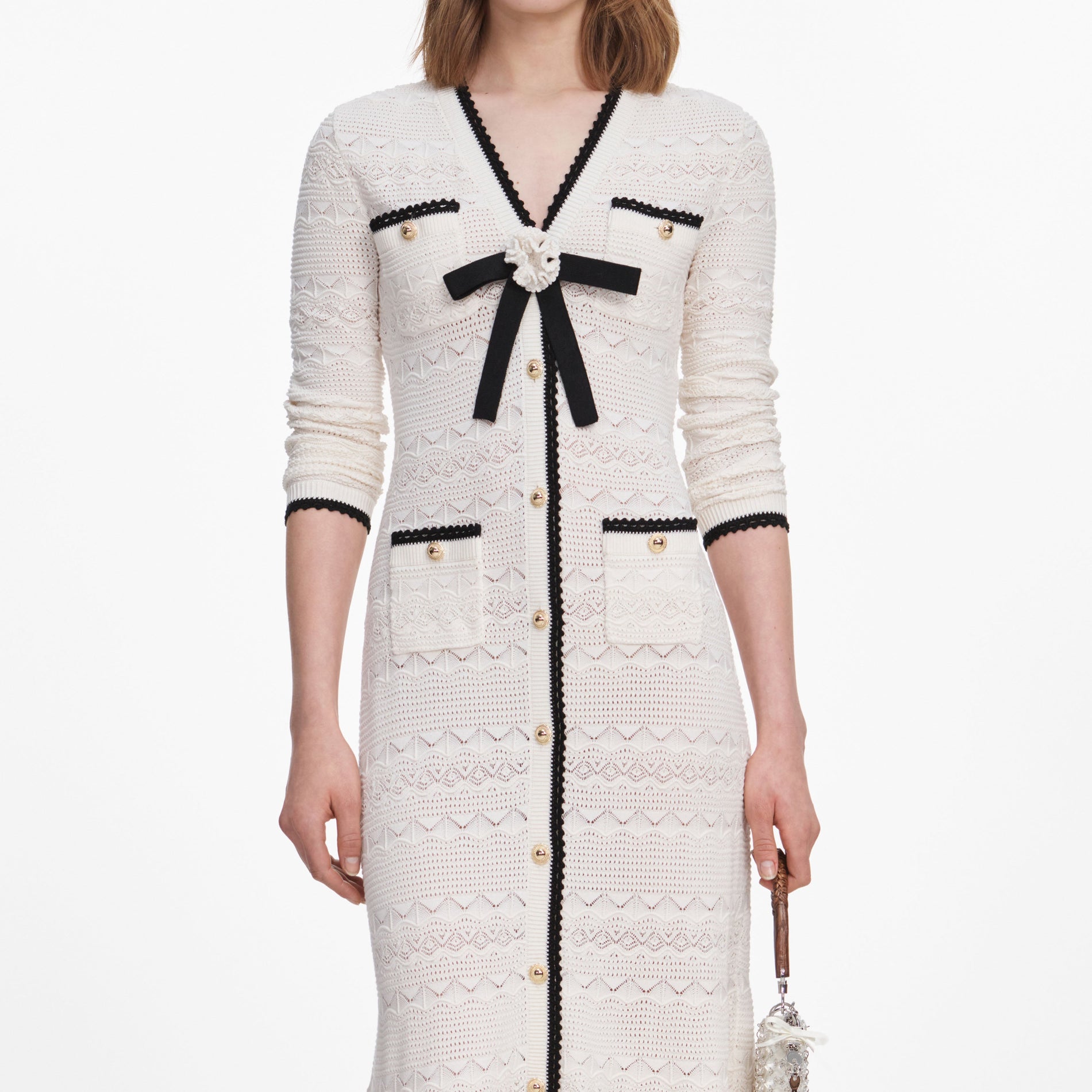 A close up of a woman wearing the White Pointelle Knit Long Cardigan