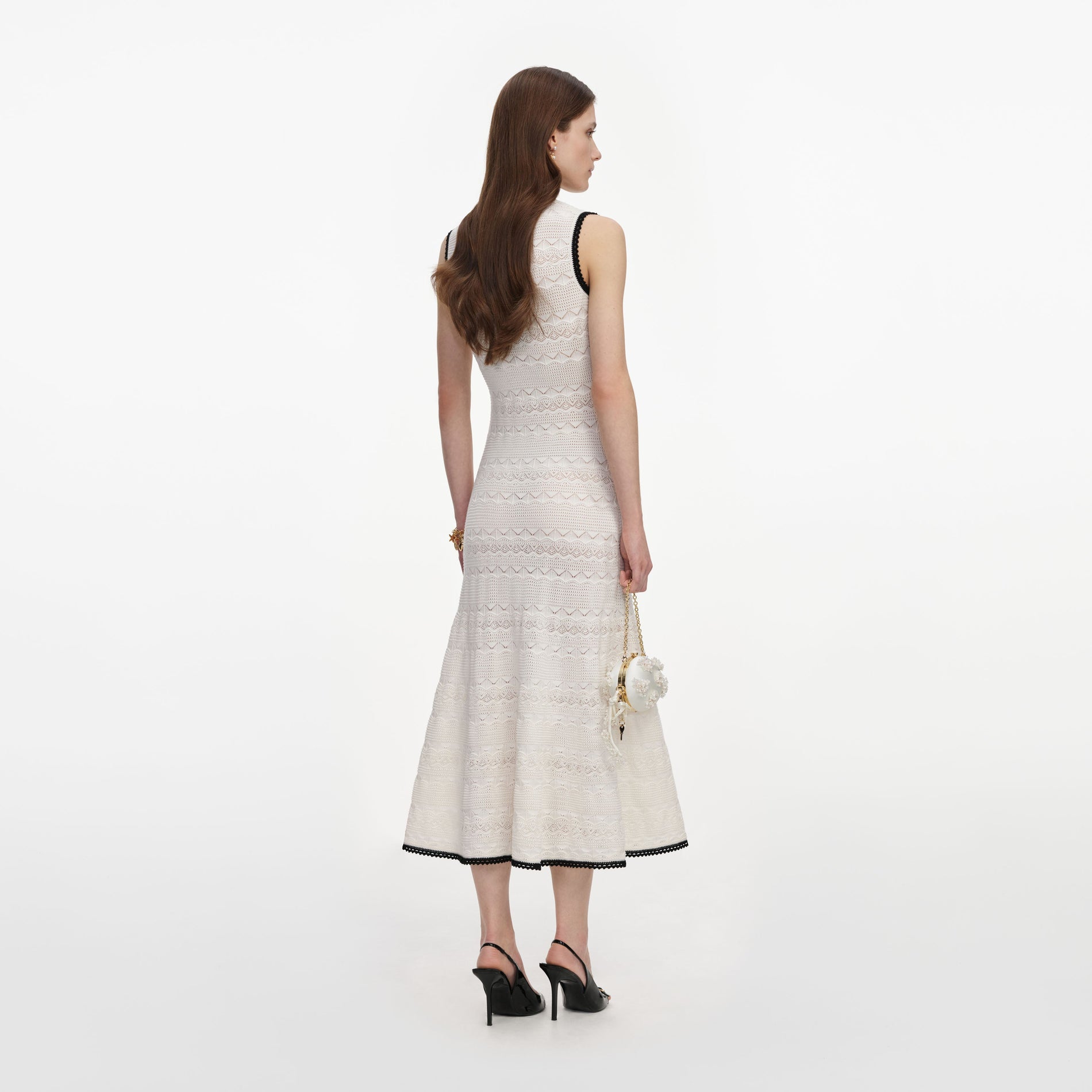 Back view of a woman wearing the White Pointelle Knit Midi Dress