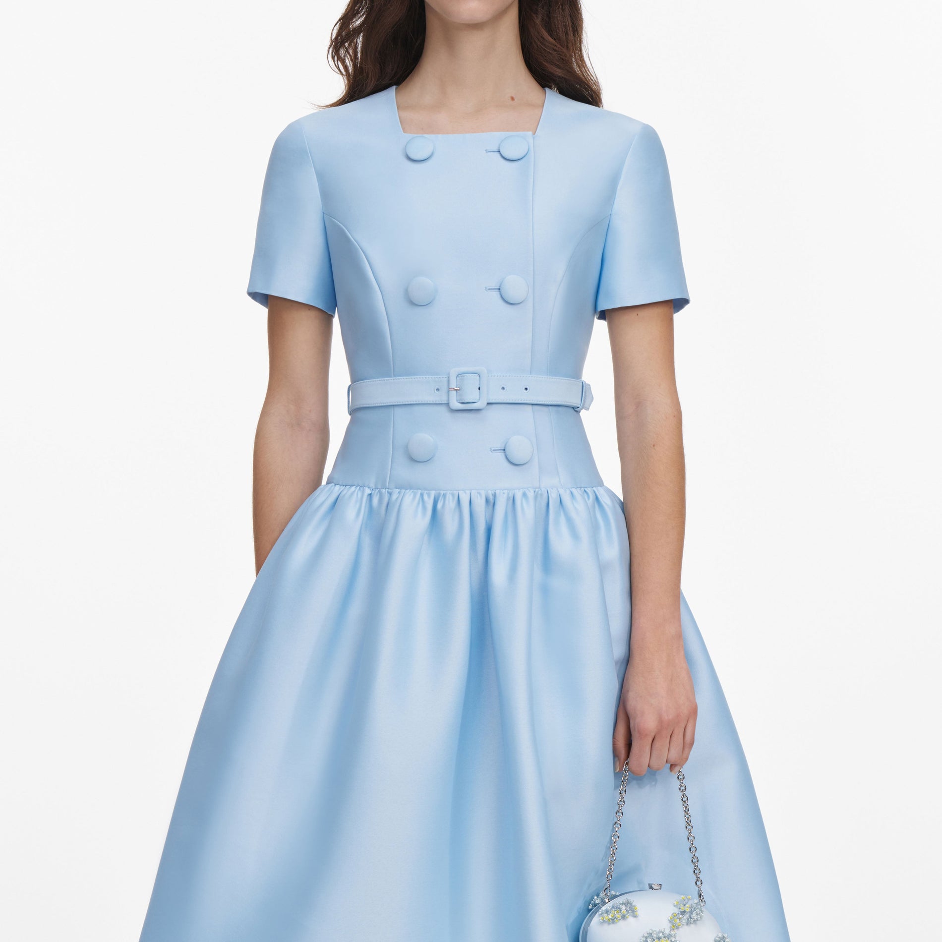 A close up of a woman wearing the Blue Button Front Taffeta Midi Dress