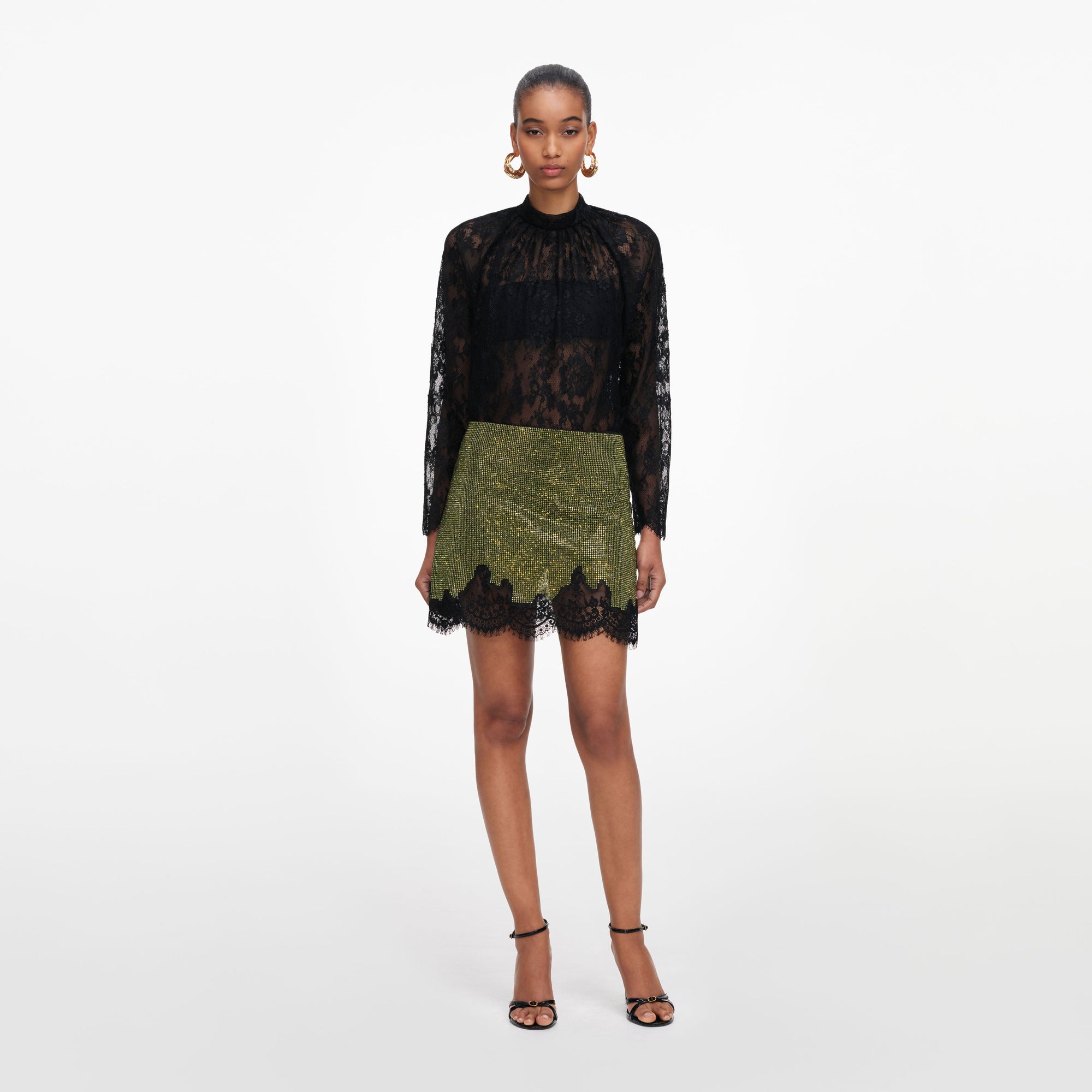 Front view of a woman wearing the Green Crystal Chainmail Mini Skirt