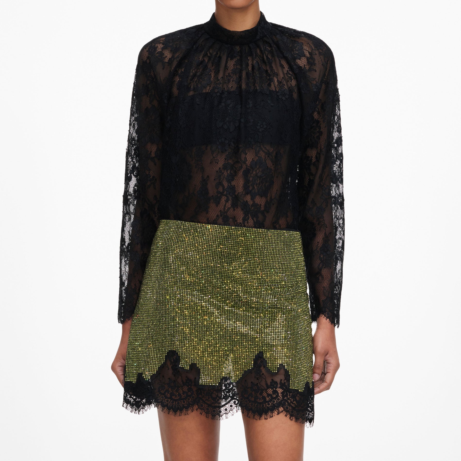 A close up of a woman wearing the Green Crystal Chainmail Mini Skirt