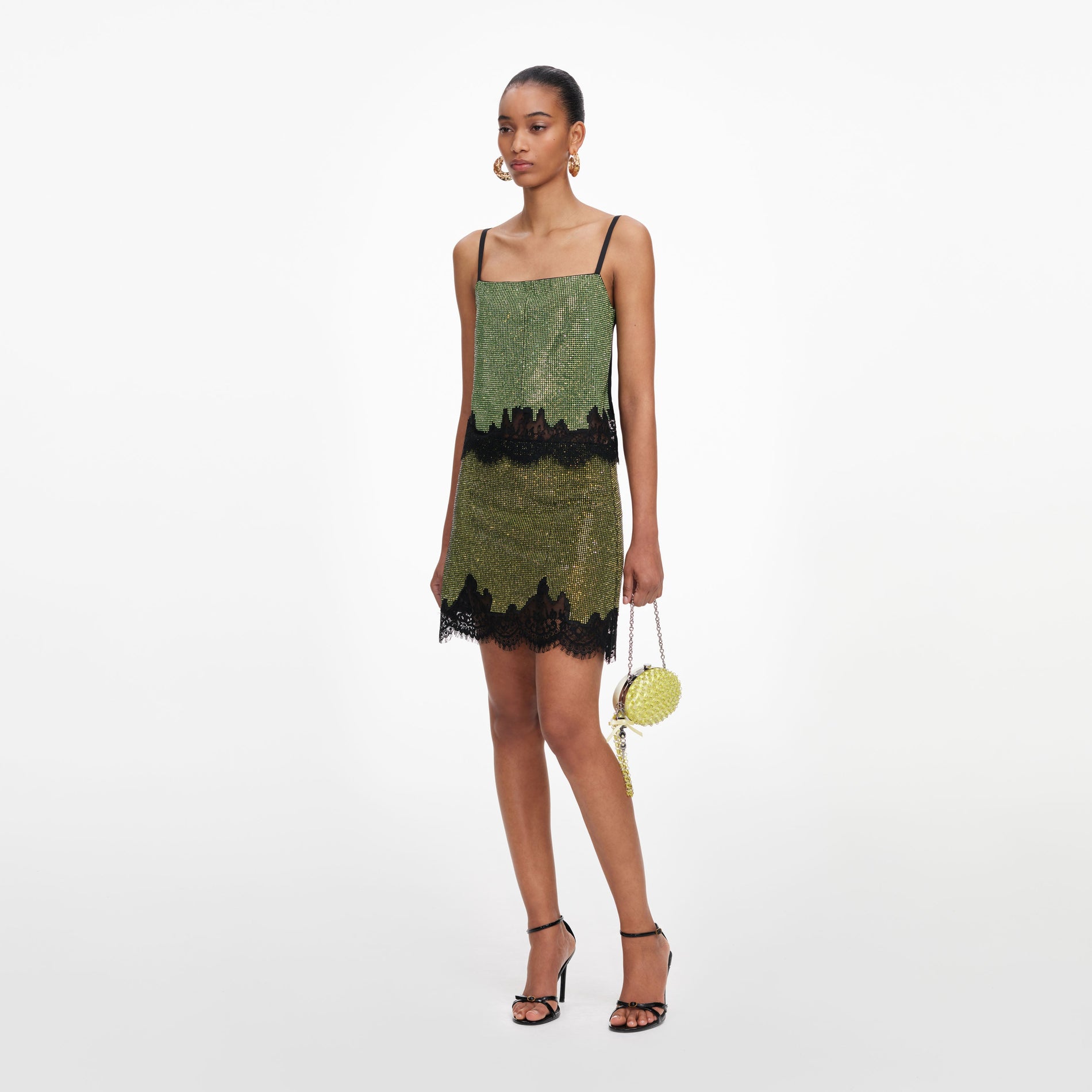 Side view of a woman wearing the Green Crystal Chainmail Top