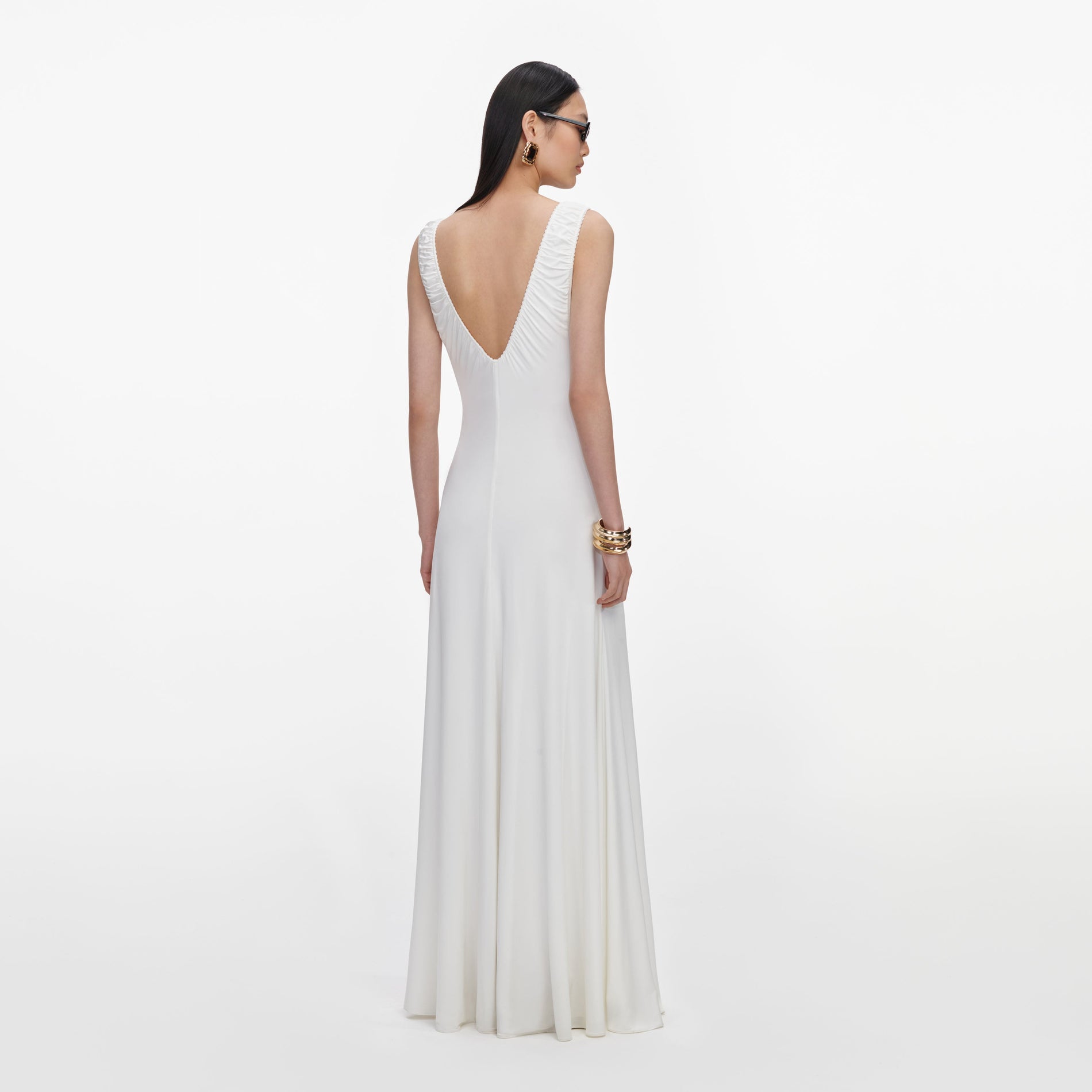 Back view of a woman wearing the White Jersey Ruched Maxi Dress