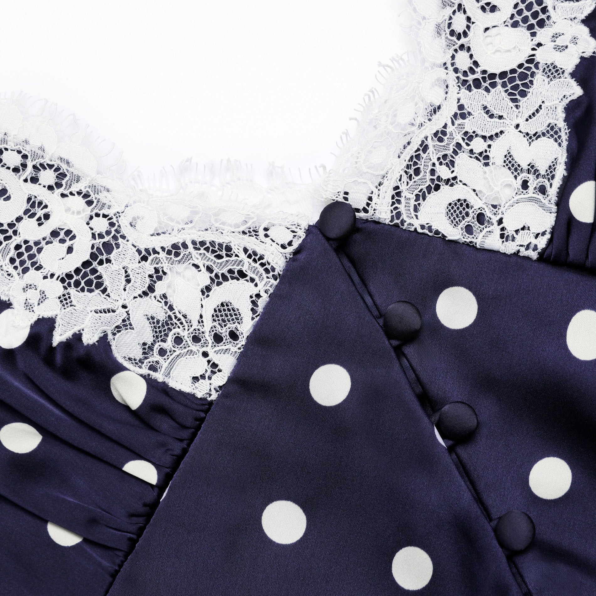 A close up of a fabric of Navy Polka Dot Satin Midi Dress
