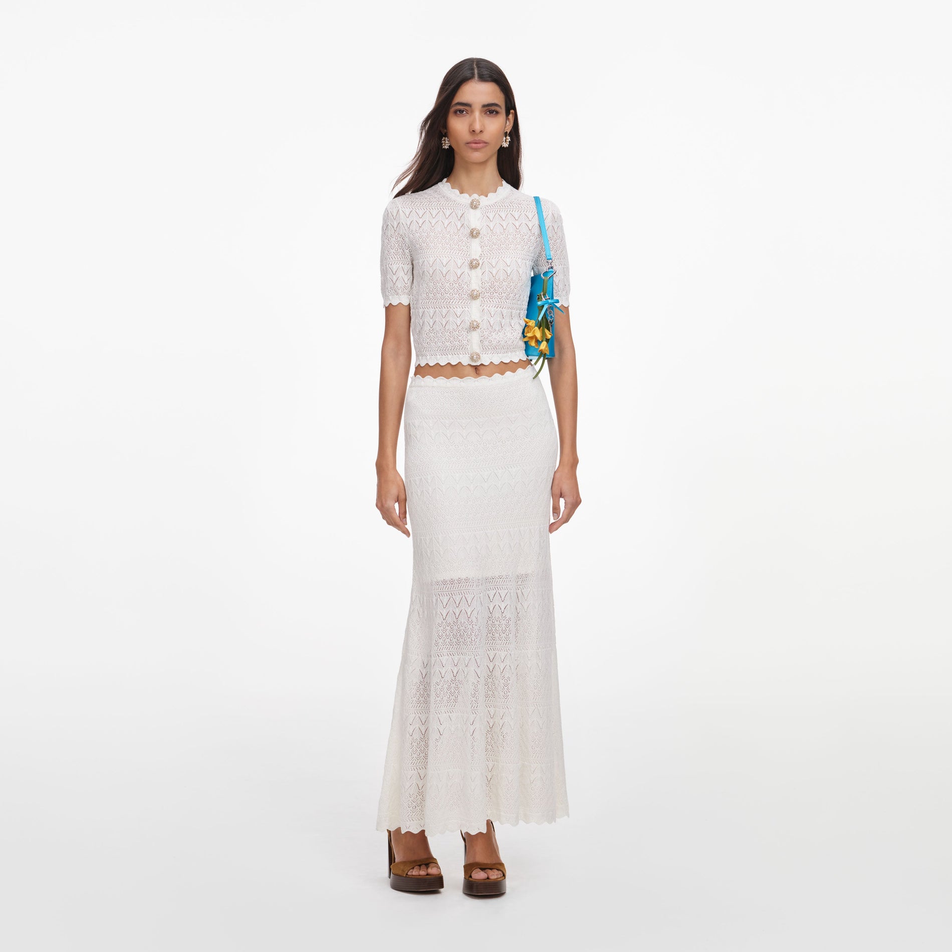 Front view of a woman wearing the White Pointelle Knit Midi Skirt