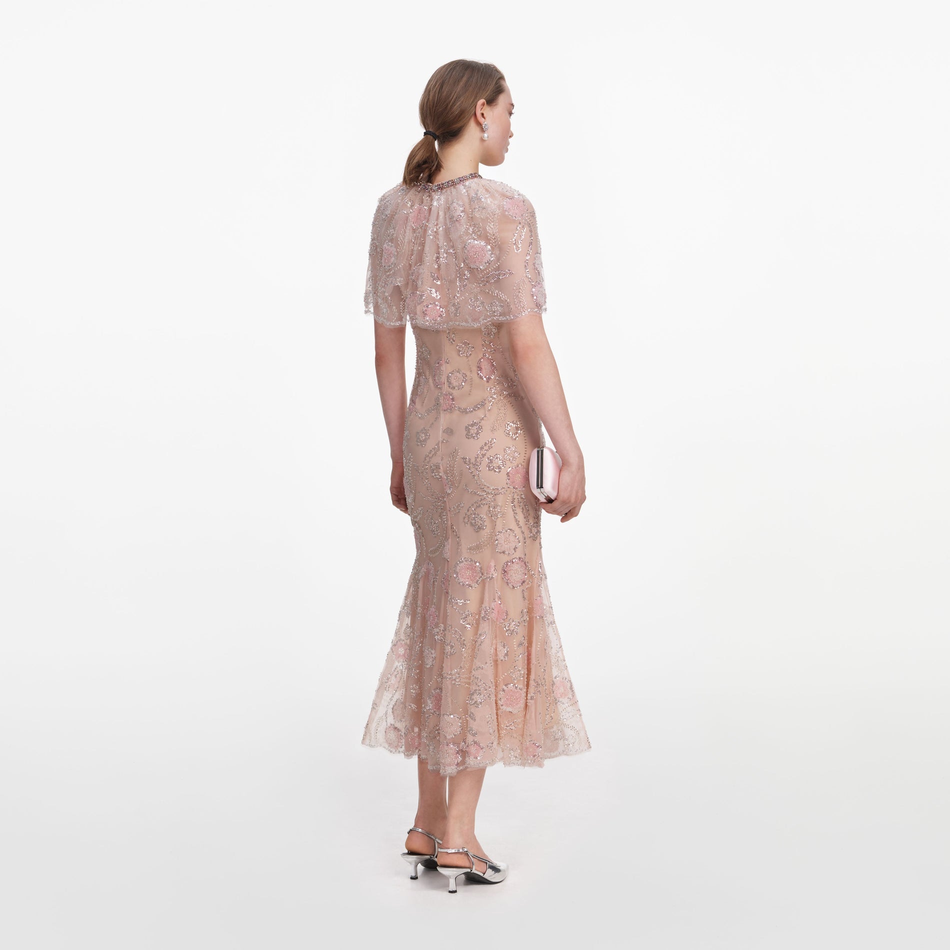 Back view of a woman wearing the Pink Embellished Cape Midi Dress