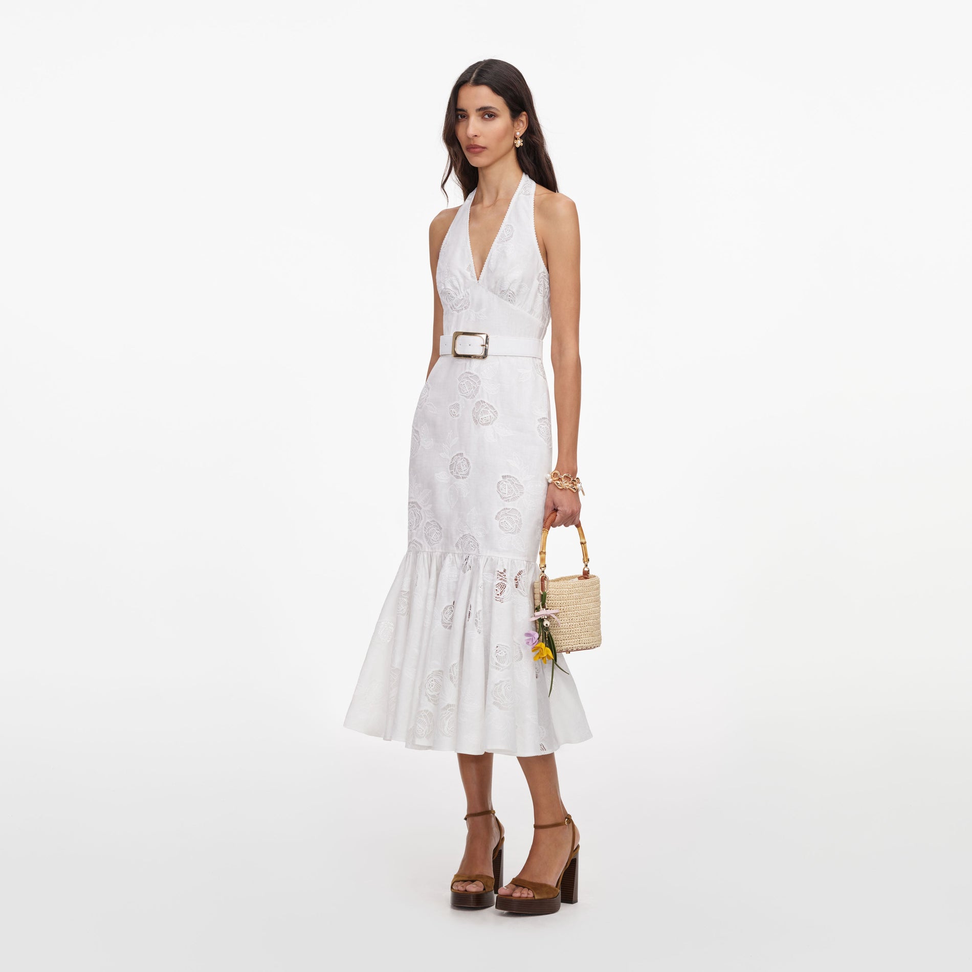 Side view of a woman wearing the White Linen Blend Halterneck Midi Dress