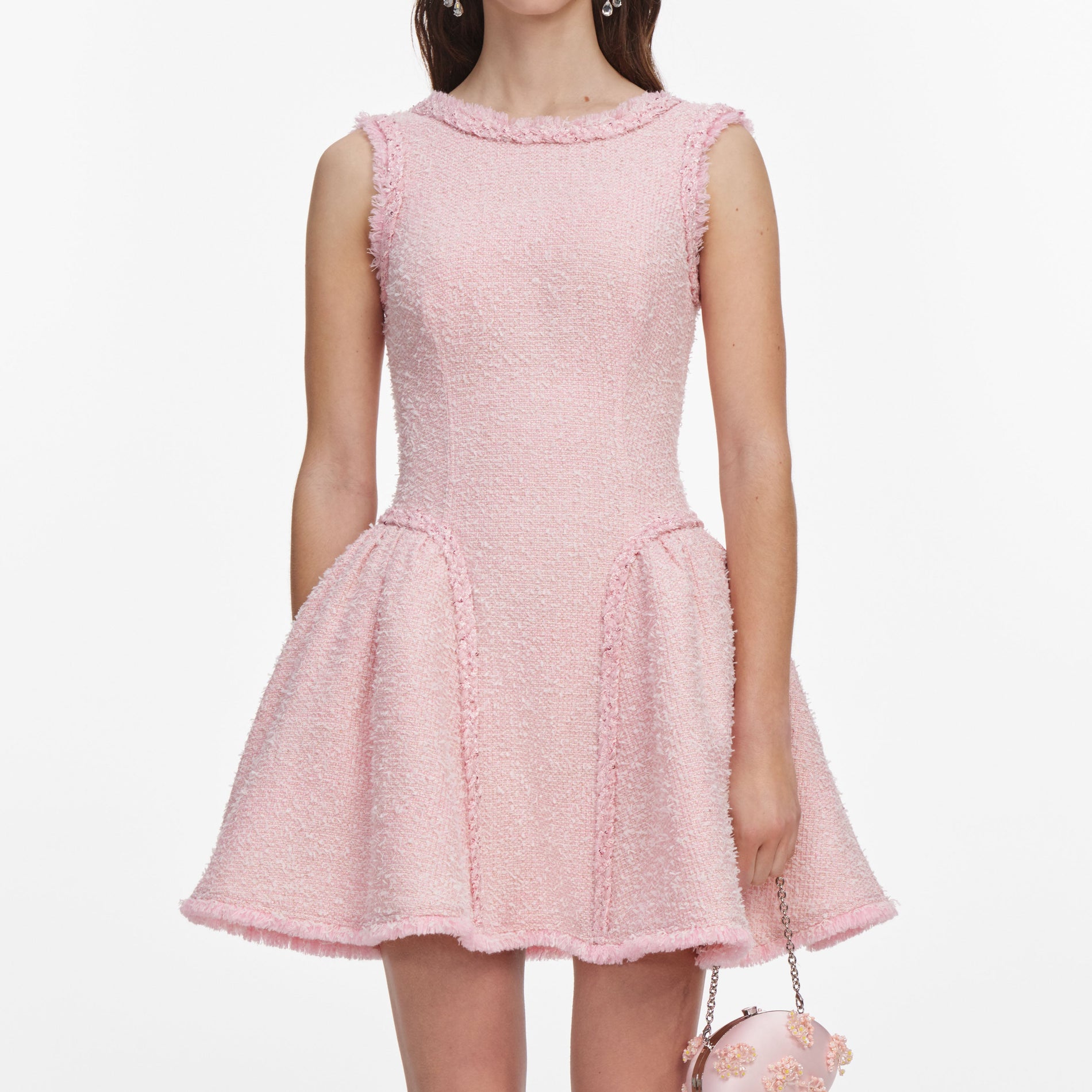 A close up of a woman wearing the Pink Boucle Sleeveless Mini Dress