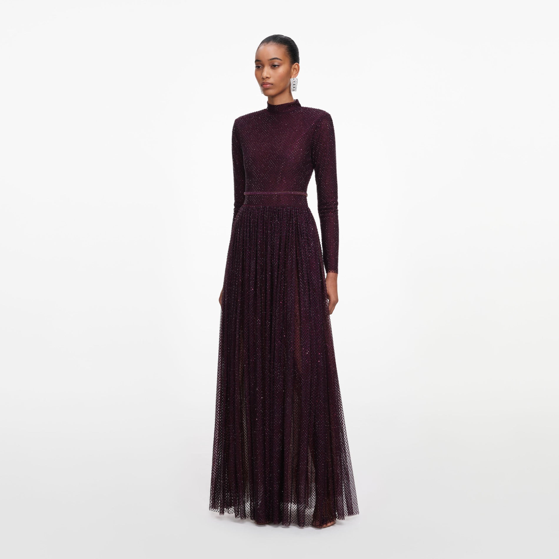 Side view of a woman wearing the Burgundy Rhinestone Long Sleeve Maxi Dress
