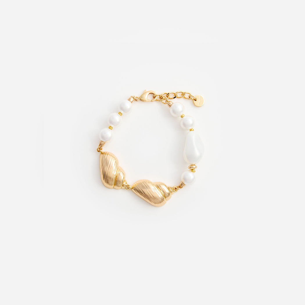 Gold bracelet with white pearls and two textured gold shell-like charms