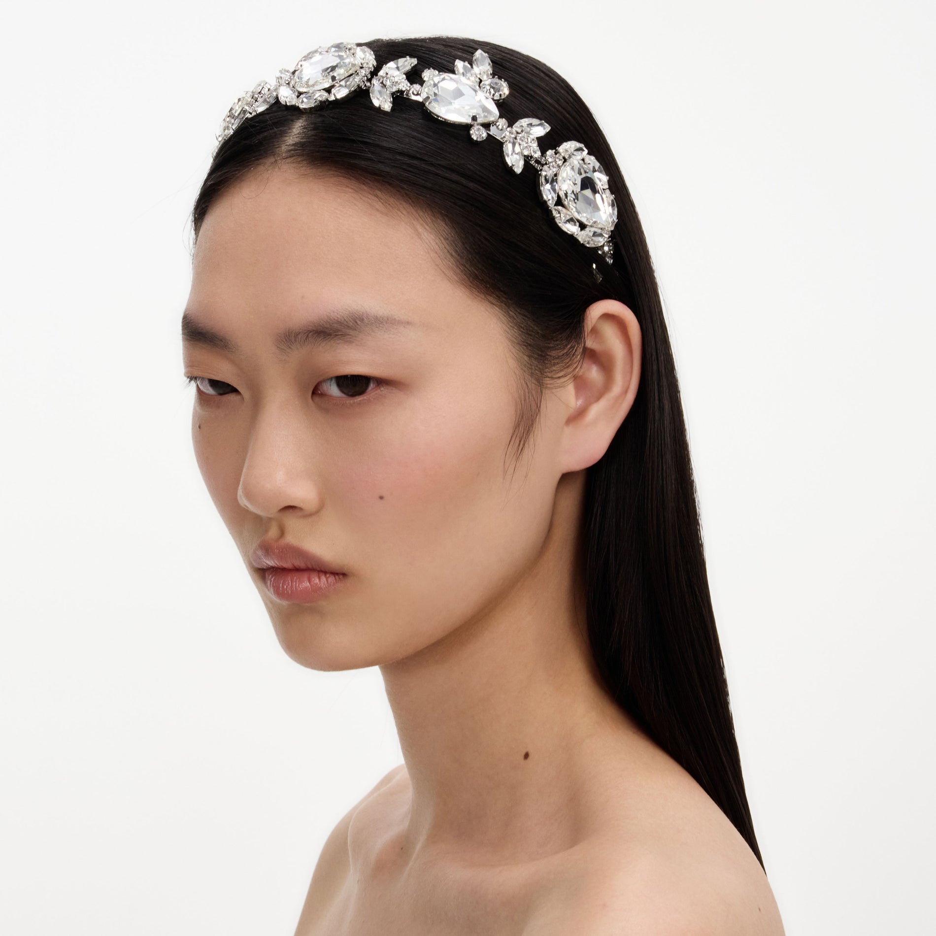 A close up of a woman wearing the Multi Crystal Headband