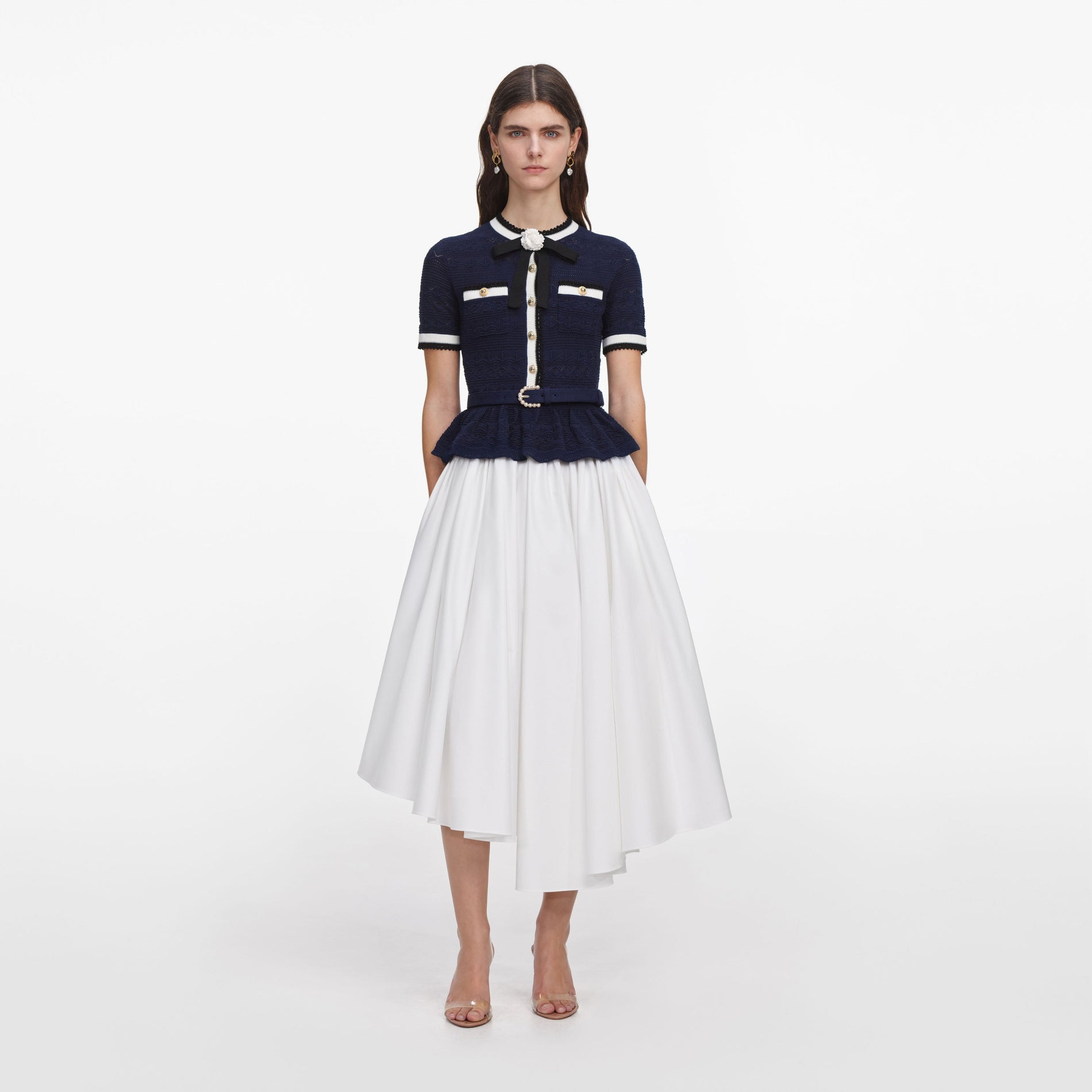 Front view of a woman wearing the Navy Peplum Pointelle Knit Top