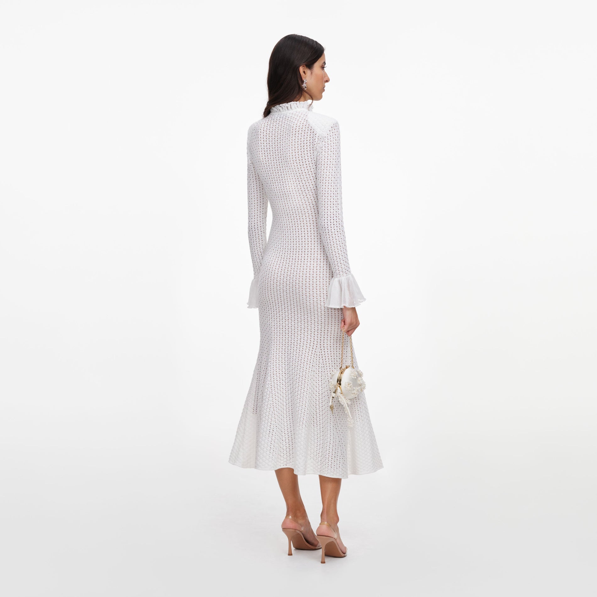 Back view of a woman wearing the White Pointelle Knit Flare Midi Dress