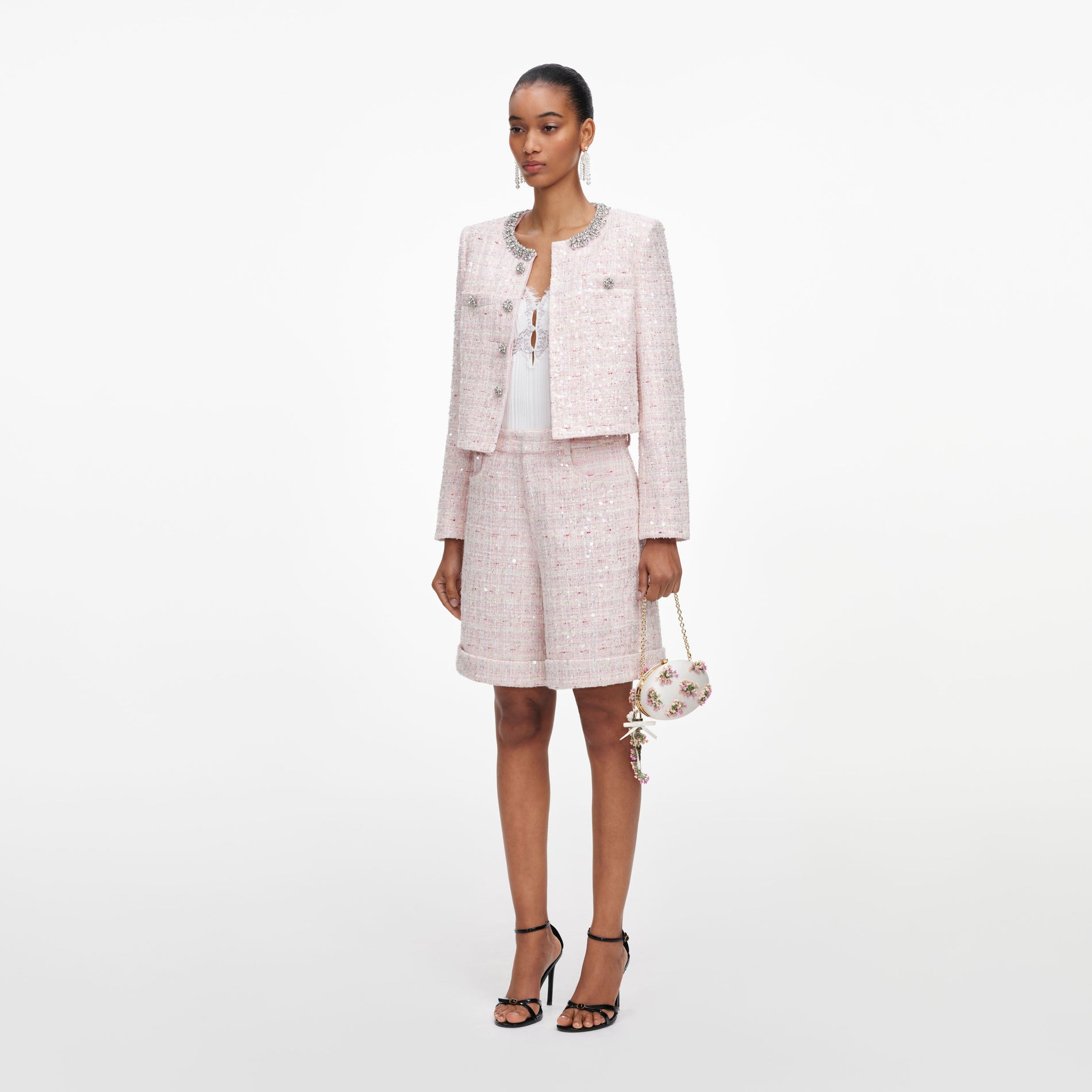 Side view of a woman wearing the Pink Sequin Boucle Shorts